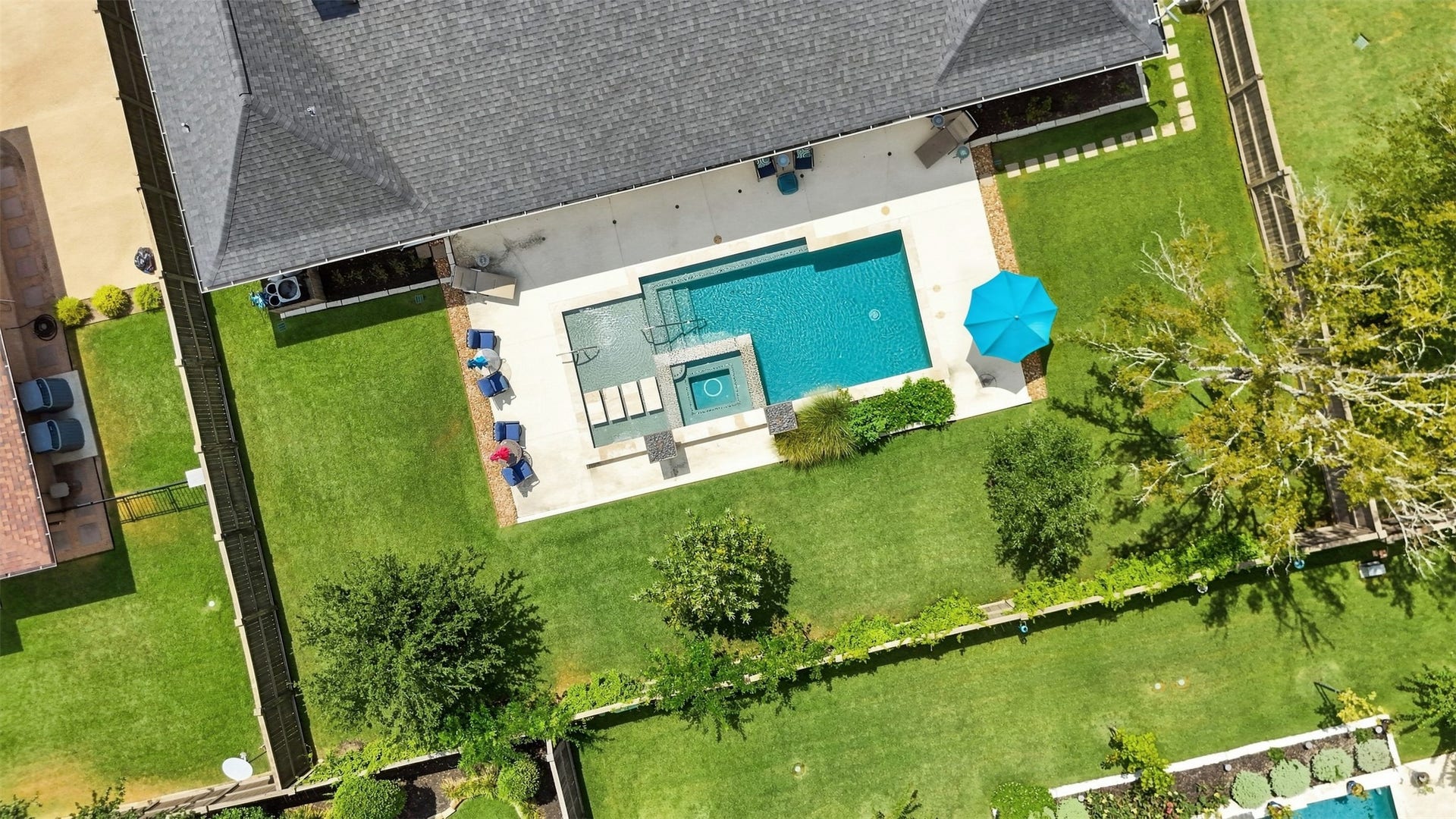 5117 Inverness Drive, Bryan, TX 77802 Aerial view showcasing the private backyard, pool and spa, multiple lounging areas, and generous green space.