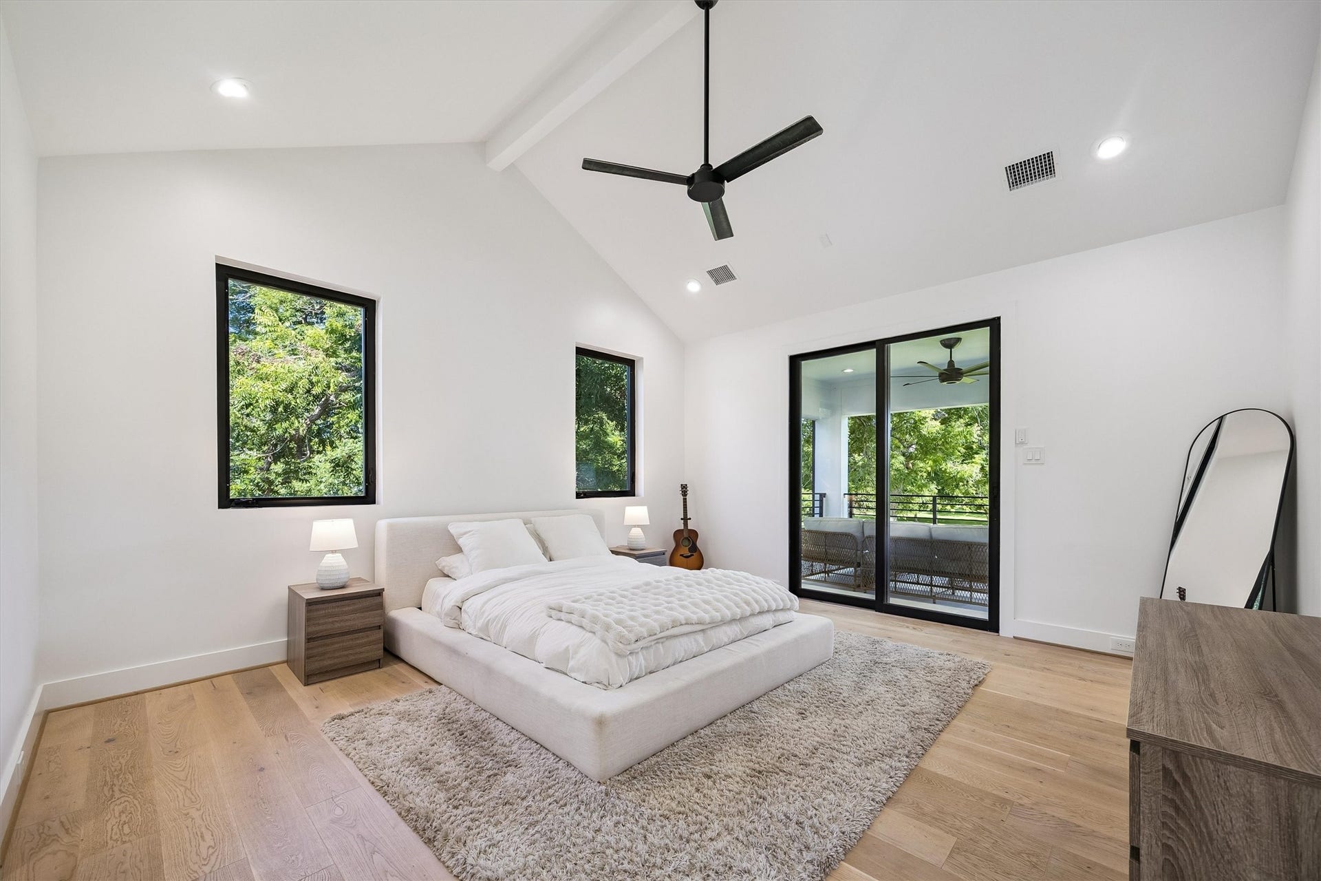 5210 Manor Drive, Sugar Land, TX 77479 Soaring ceilings, abundant natural light, and expansive glass doors opening toward a private balcony create a peaceful retreat with a delightful connection to the outdoors.