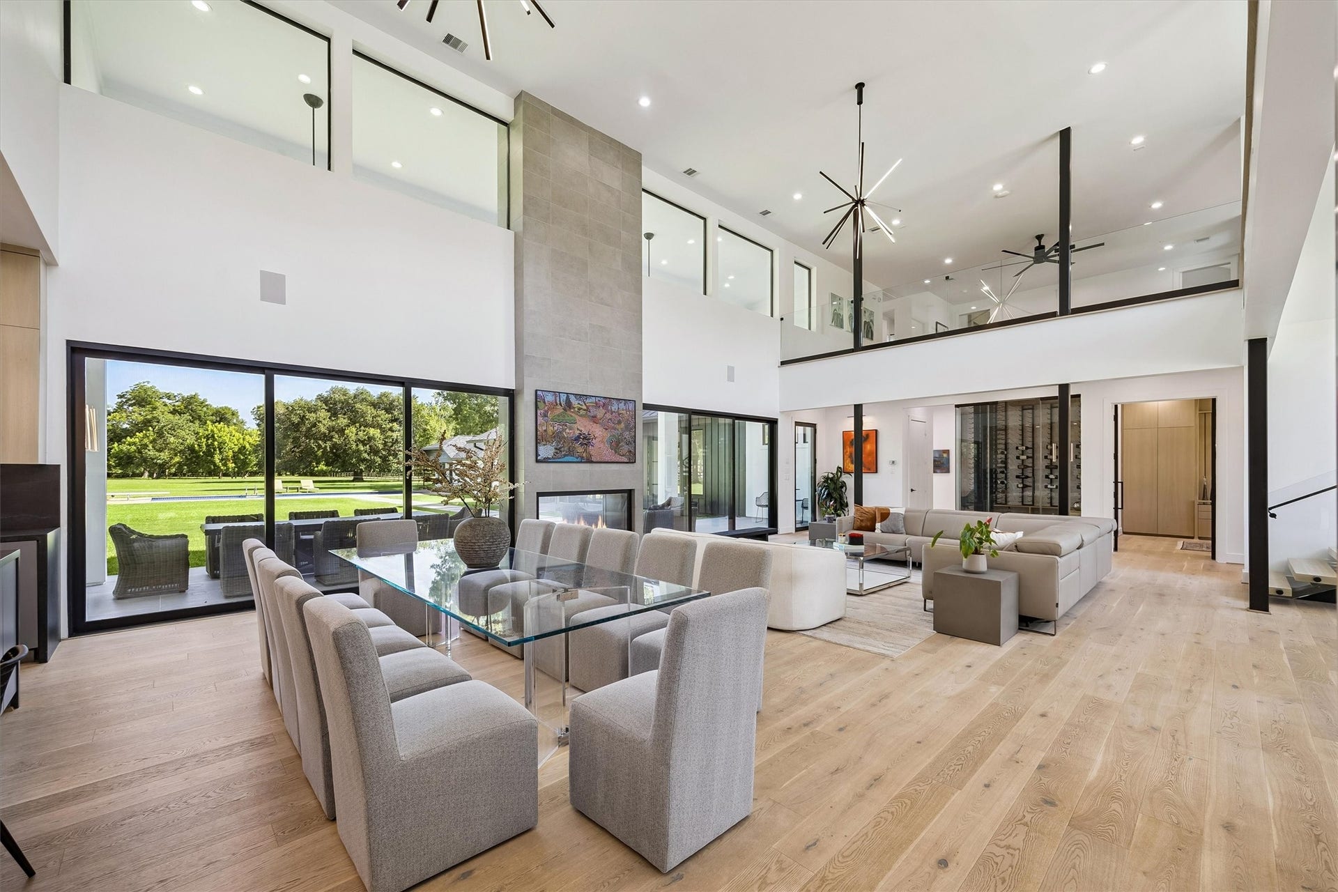 5210 Manor Drive, Sugar Land, TX 77479 Expansive walls of glass dissolve the boundaries between indoors and out, framing picturesque views of the grounds while filling the grand living and dining spaces with natural light.