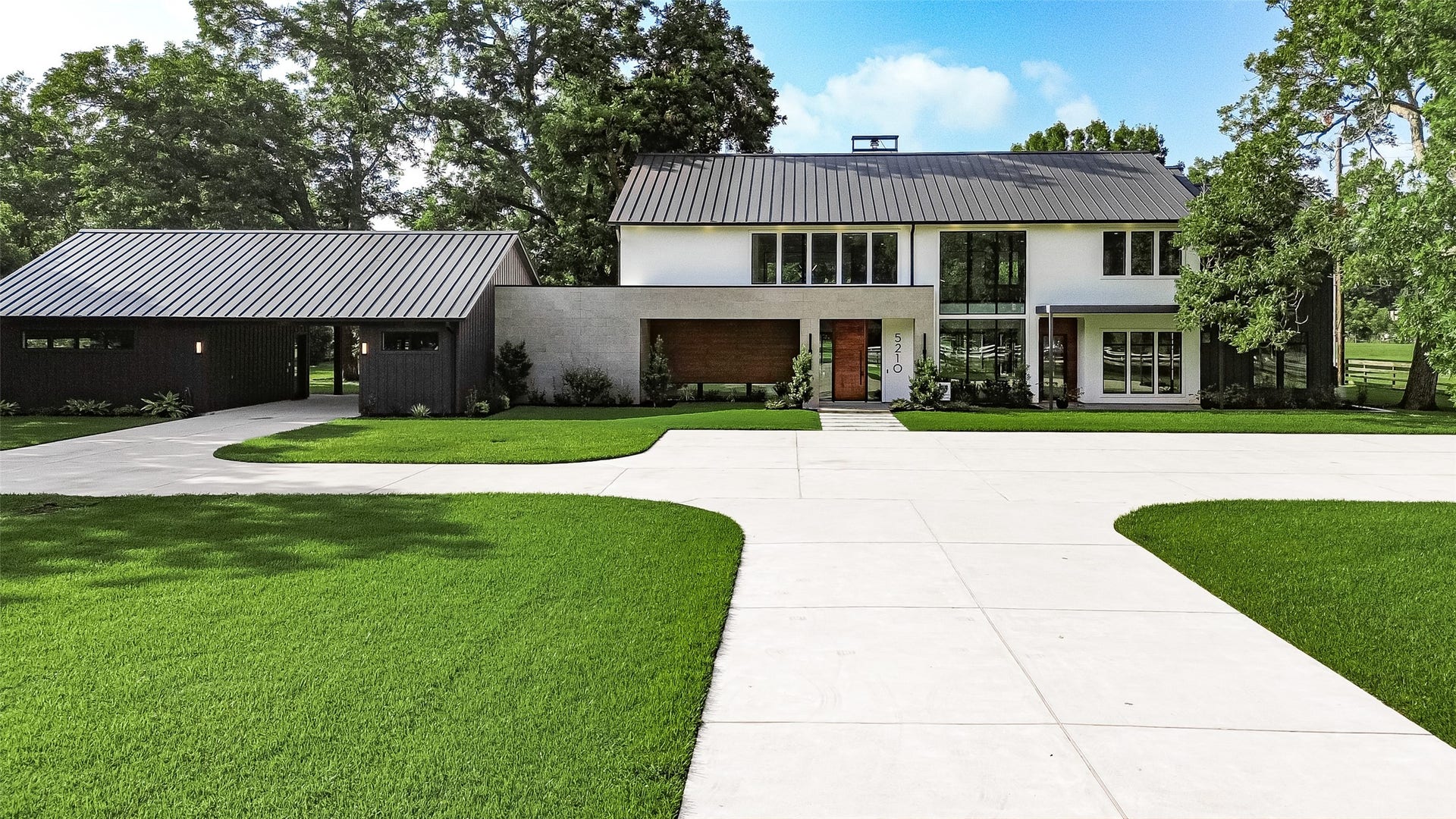 5210 Manor Drive, Sugar Land, TX 77479 Striking contemporary architecture meets timeless sophistication, with a distinctive metal roof, dramatic windows, and beautifully maintained lawns creating an unforgettable first impression.
