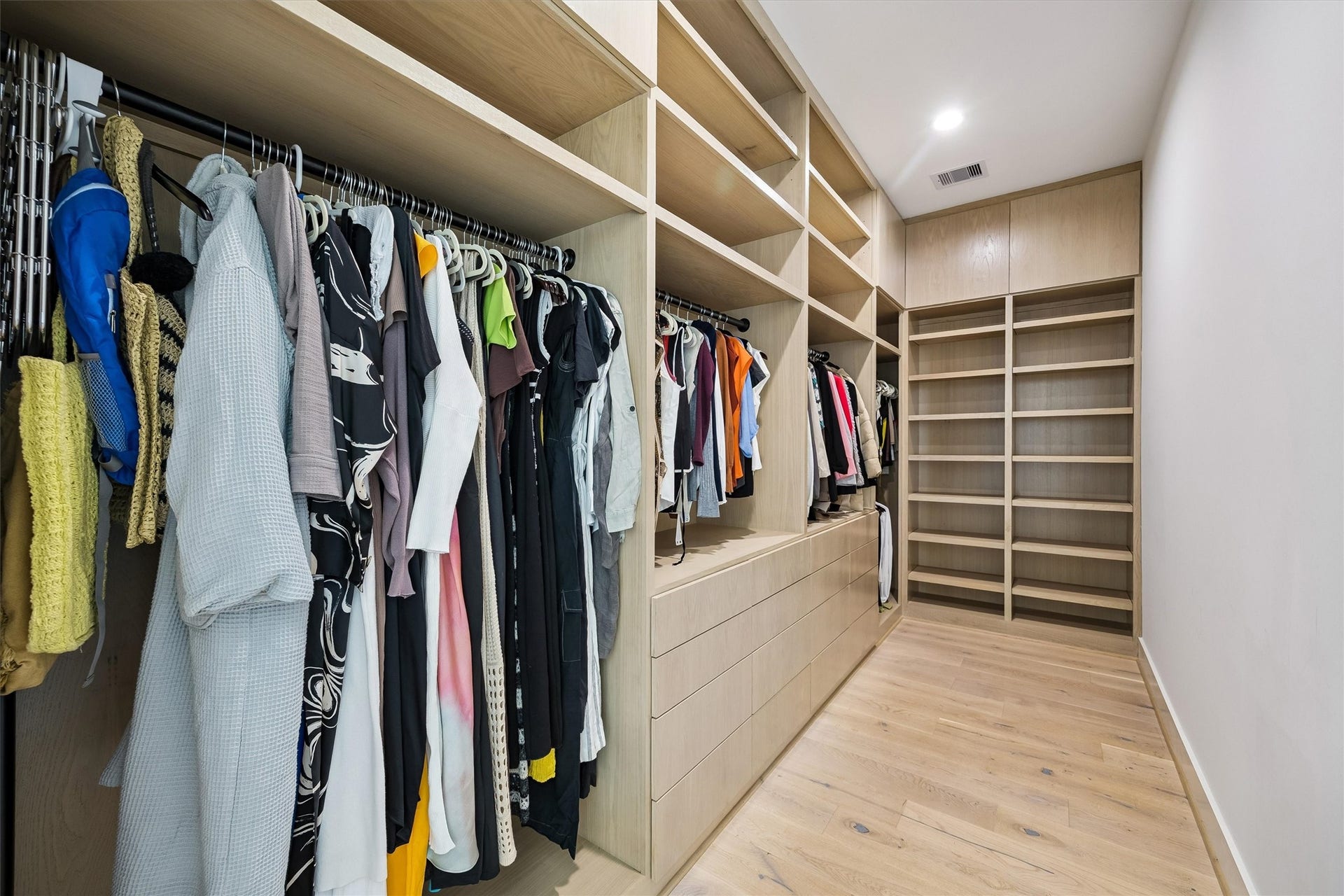 5210 Manor Drive, Sugar Land, TX 77479 A second generously proportioned dressing room features extensive custom shelving, hanging space, and elegant wood finishes, offering exceptional organization and convenience.