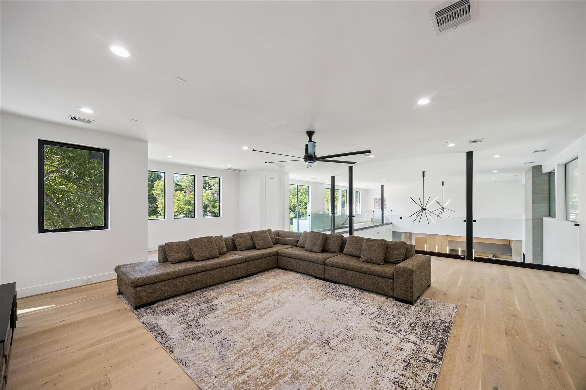 5210 Manor Drive, Sugar Land, TX 77479 A generous secondary living space offers endless possibilities for recreation, relaxation, or entertaining, with beautiful wood flooring, contemporary lighting, and an open, comfortable layout.