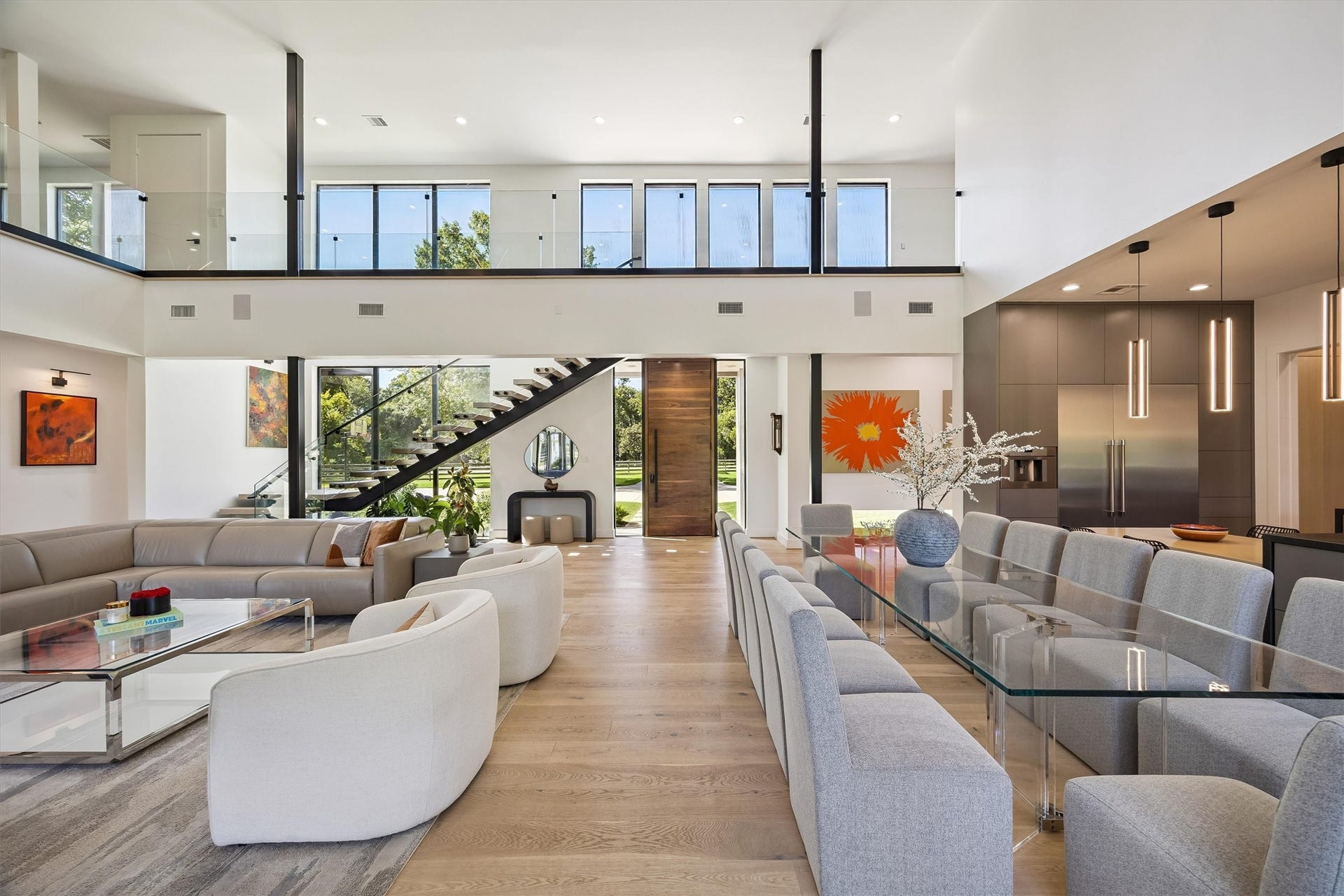 5210 Manor Drive, Sugar Land, TX 77479 Breathtaking two-story interiors unfold beneath soaring ceilings, where contemporary design, dramatic glass railings, and thoughtfully connected living spaces create an extraordinary setting for entertaining.