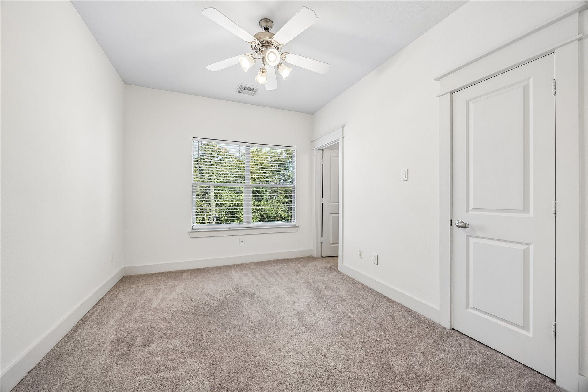 The third bedroom on the third floor features a closet and ensuite bathroom