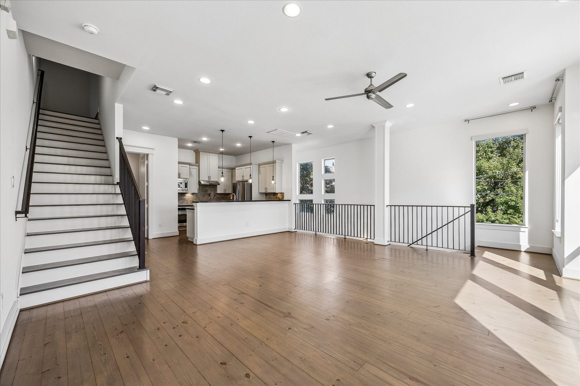 Ascend the stairs to the third floor with the primary bedroom and a third bedroom