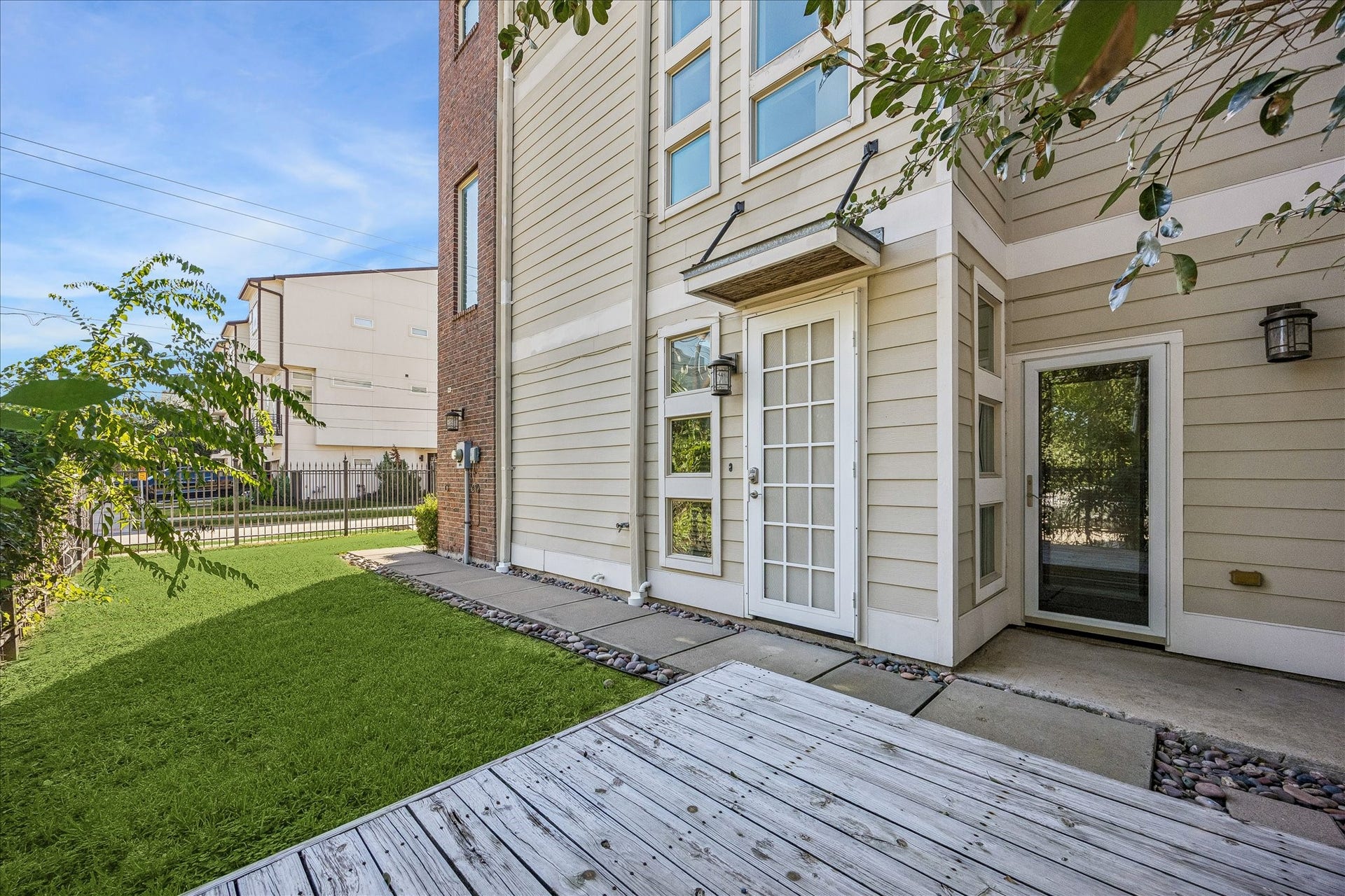 Within the fenced yard, is the walking path that leads to the front door