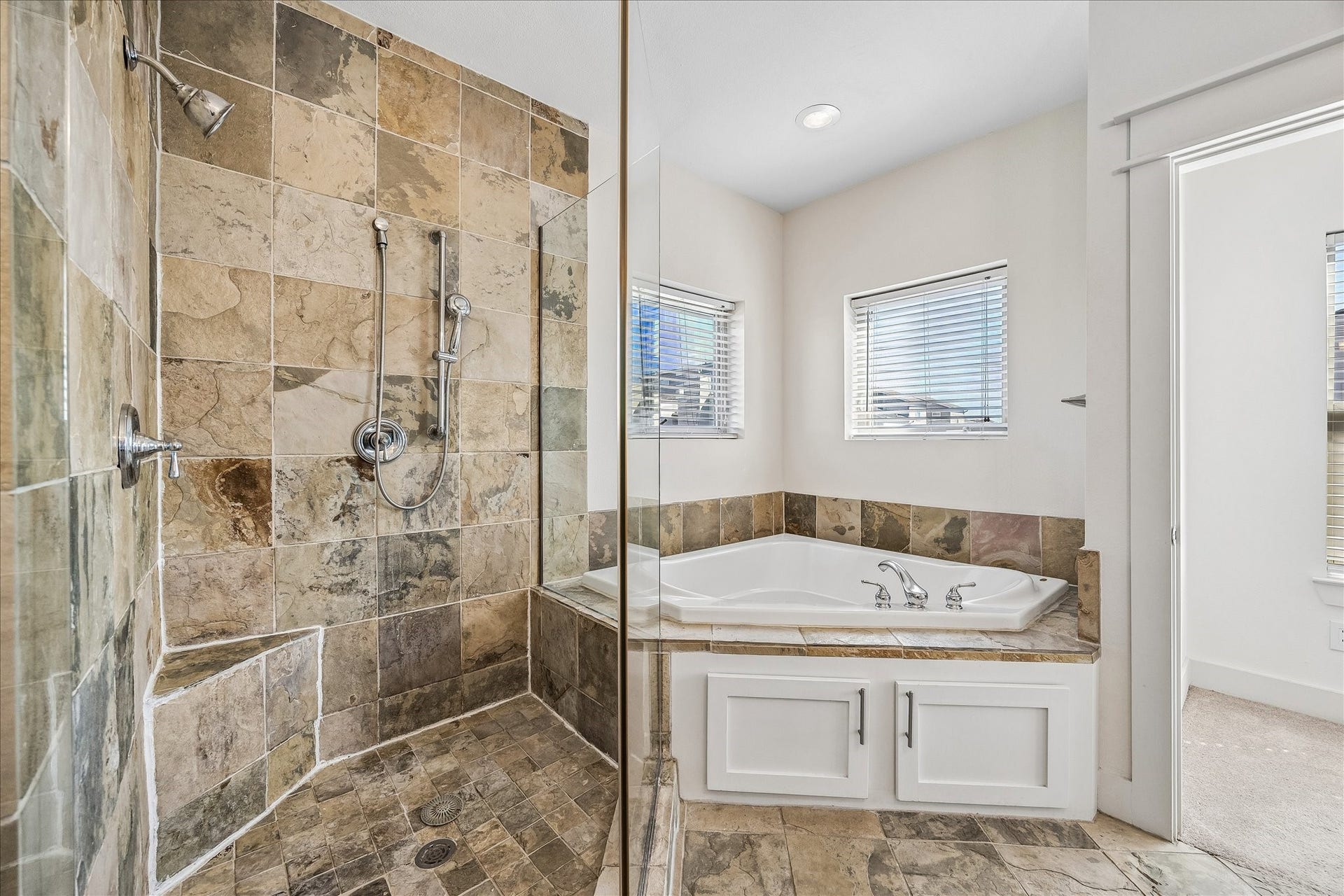 The primary bathroom also has a walk-in shower and large bathtub for those long days