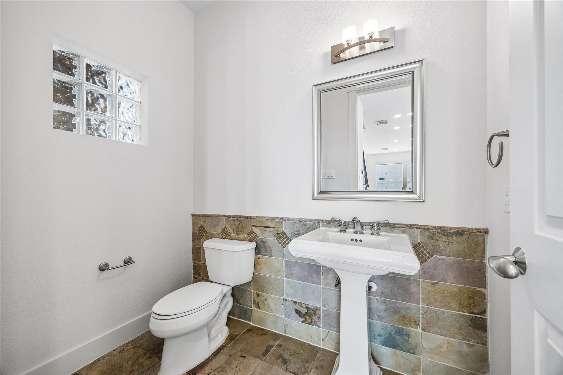 Off the kitchen, conveniently located on the second floor is a half bath for guests