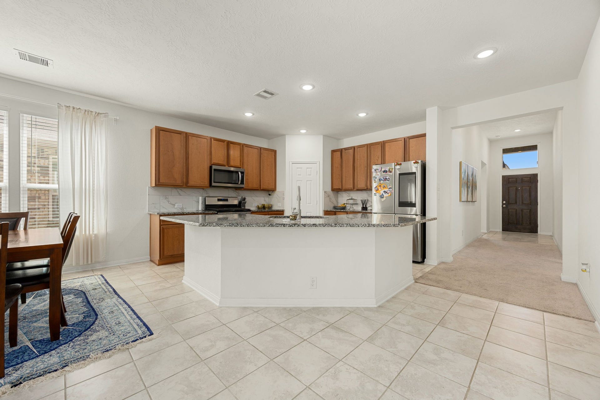 2023 Katalonia Lane, Fresno, TX 77459 This perspective highlights the exceptional flow from the front doorway straight into the central meeting area. Greet family and guests as they arrive in the bright, open great room.