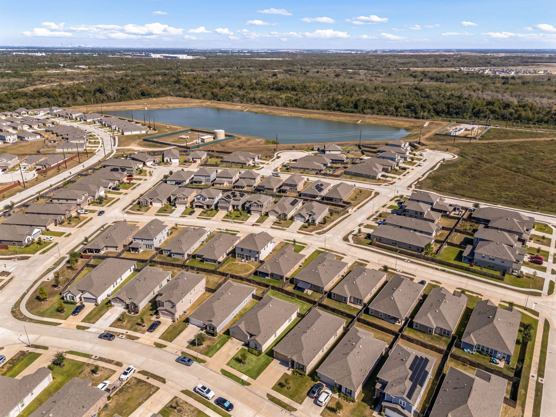 2023 Katalonia Lane, Fresno, TX 77459 Welcome to life at Olympia Falls in Fresno! This bird's-eye perspective highlights the master-planned community's extensive green space and sparkling detention lake. Designed for active and social lifestyles, the neighborhood features excellent amenities like a central park, walking trails, and a dedicated children's play area, all just moments away from your front doo