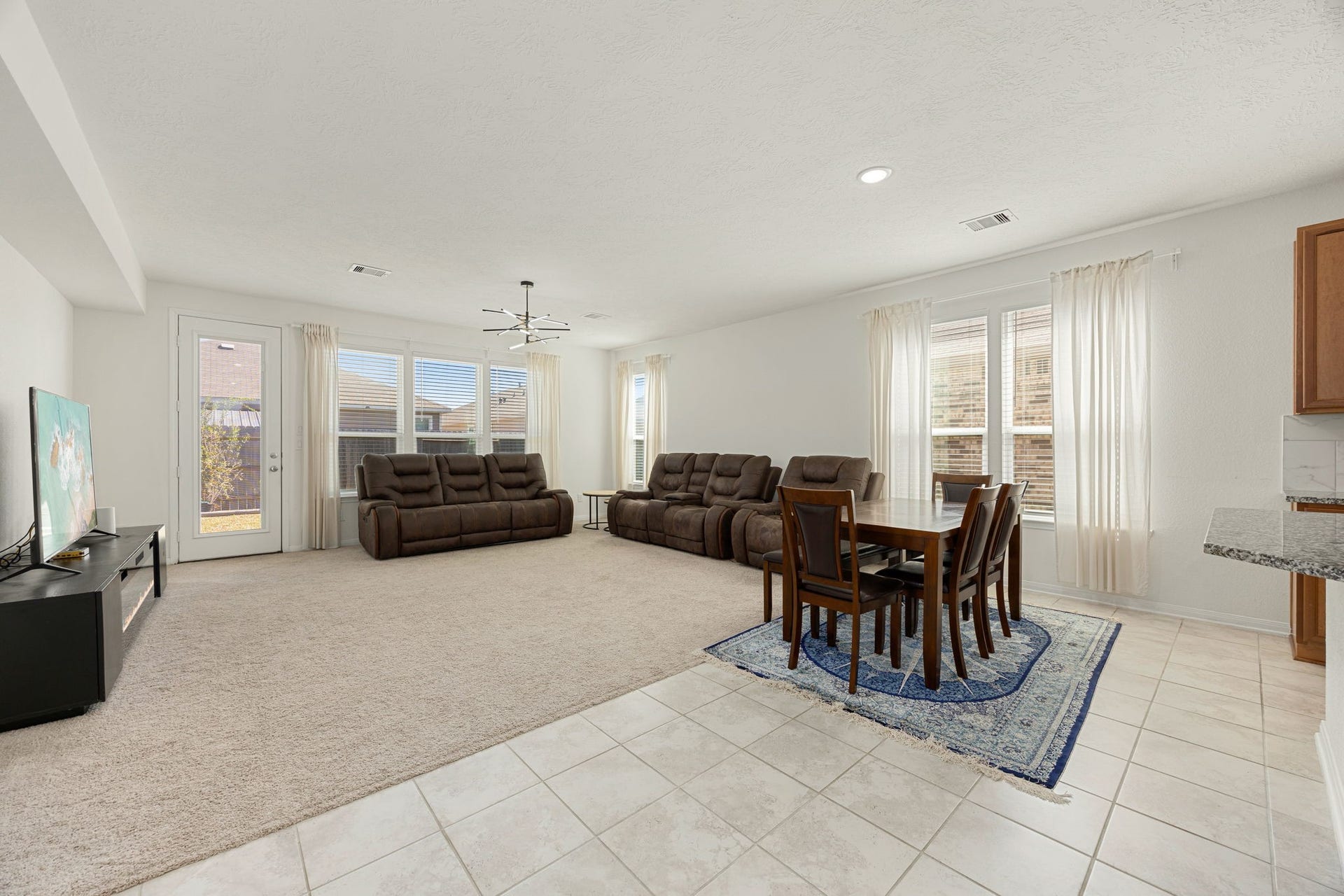 2023 Katalonia Lane, Fresno, TX 77459 The continuous flow between the casual dining area and the spacious family room defines this exceptional open-concept floor plan. Multiple oversized windows and a glass patio door line the back wall, bathing the entire great room in soft natural light while providing lovely sightlines out to the backyard.