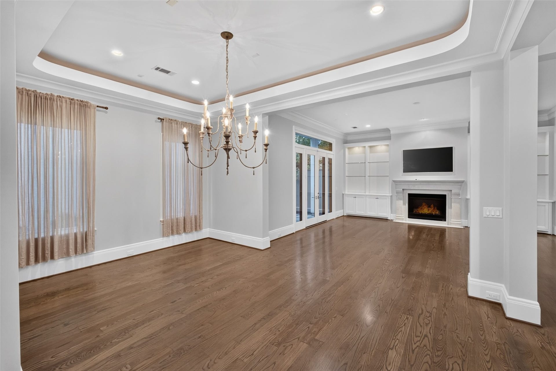 Completely open first floor! Beautiful alcove lighting, recessed lights and a beautiful chandelier grace the dining area.