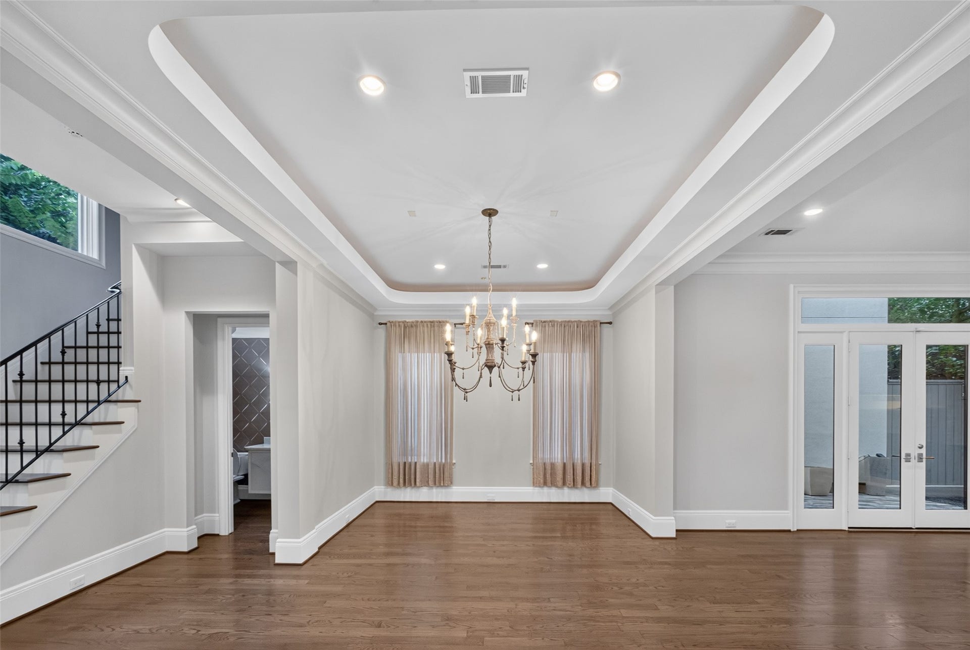 Another angle of the dining area. Tucked to the left is the powder room and the stairs illuminated by a large picture window.  There is no lack of natural light in this home!