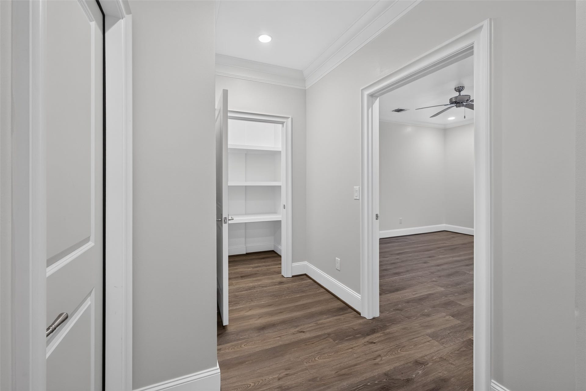 Straight ahead is the landing of the elevator shaft. To the right is the fourth bedroom and to the left the door to the walk-in attic
