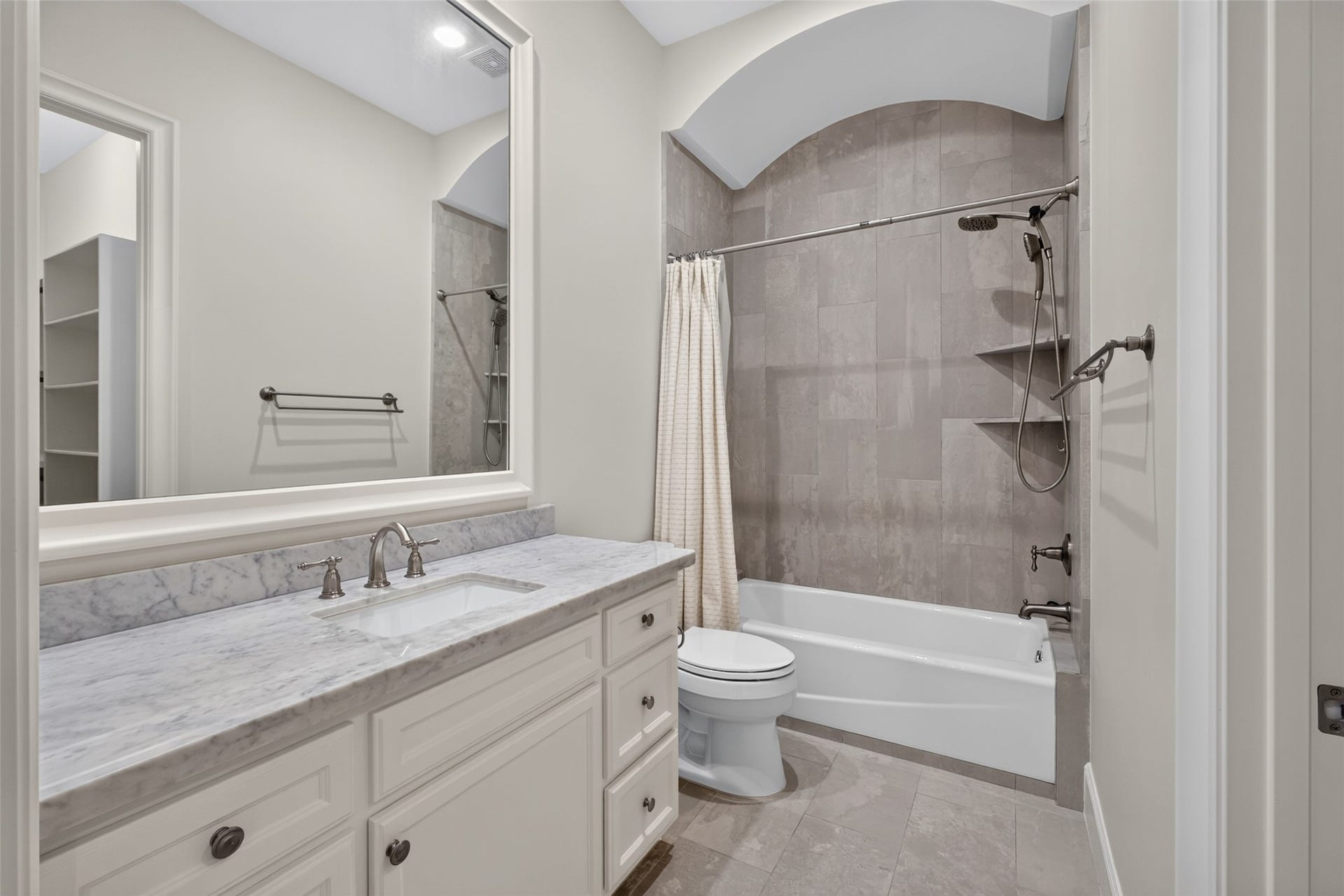 The bedroom has its own bathroom and a walk in closet