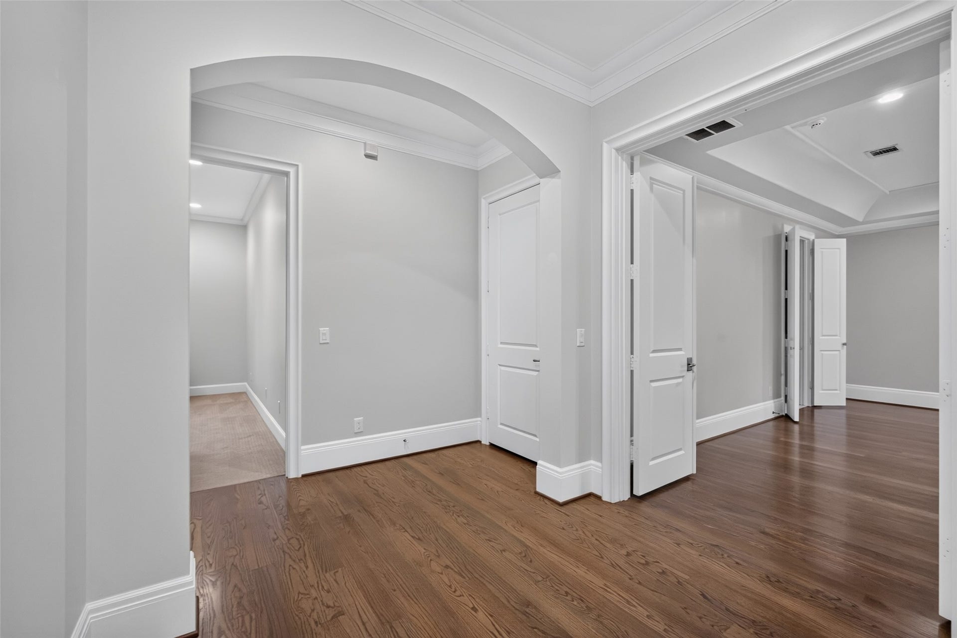 The door in the middle of the photo would be the door of the future elevator (currently a large closet).  Wide entrance to the primary bedroom.