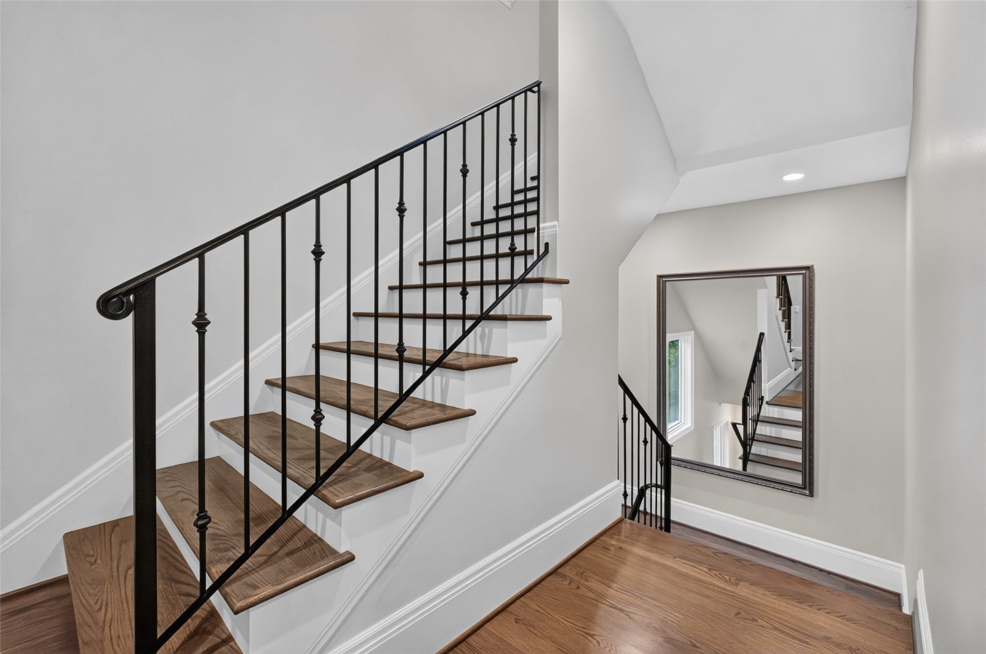 Large custom mirror on the landing conveys with the house