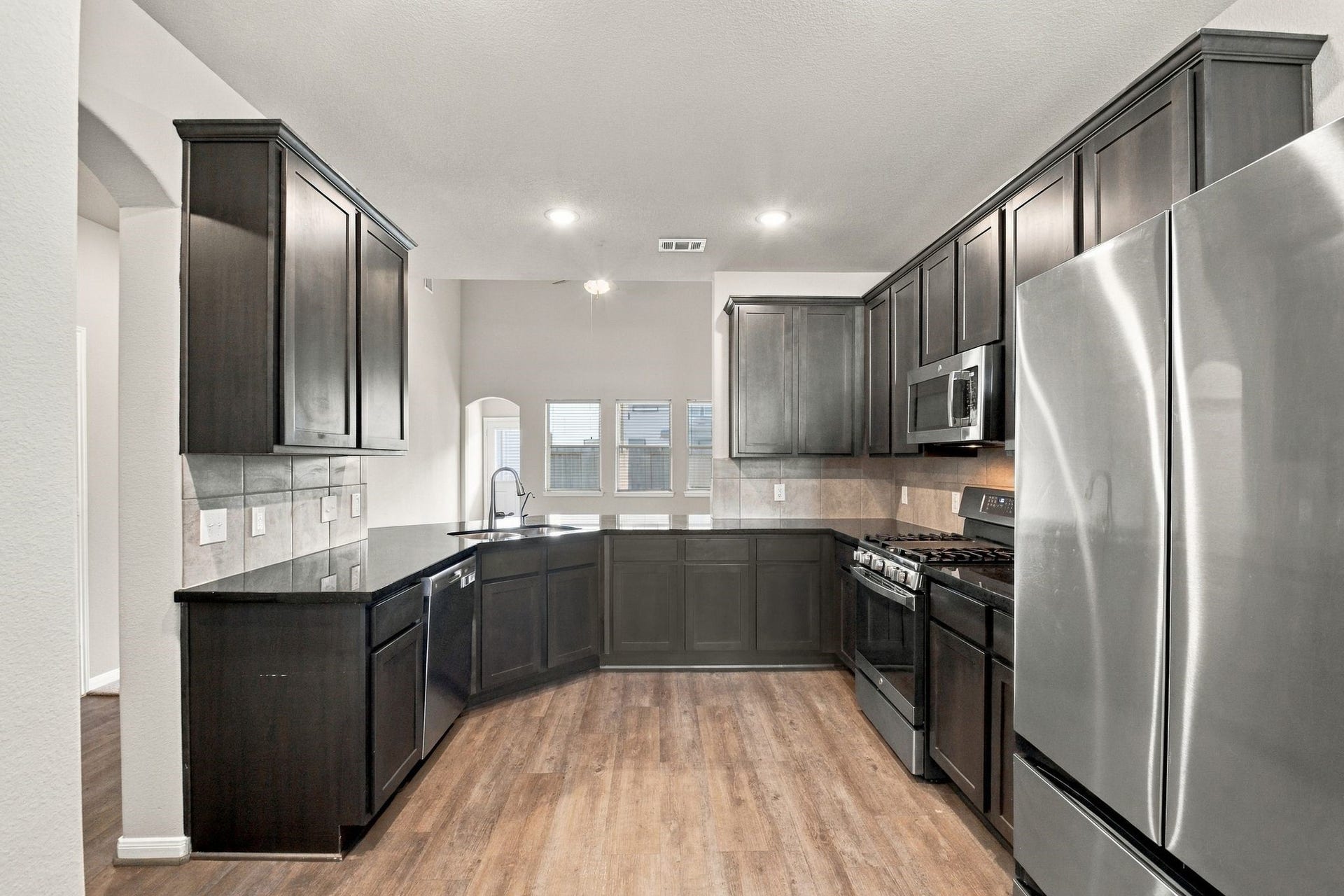 10423 Rochester Hills Lane, Tomball, TX 77375 Vinyl plank floor and stainless steel appliances