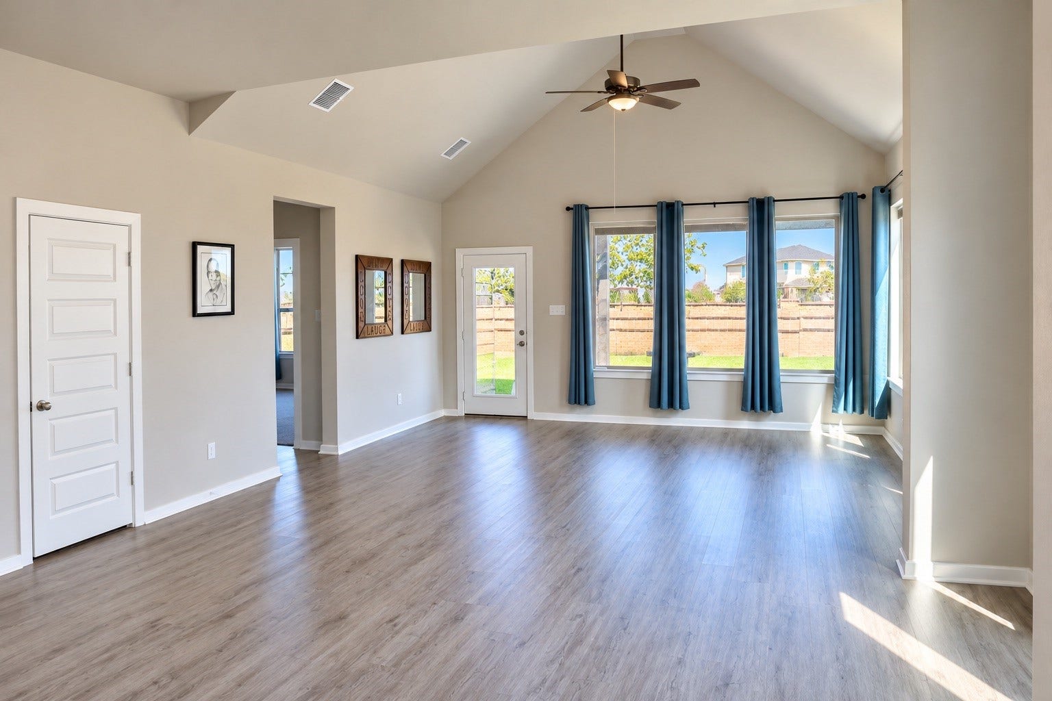 1007 Rosewood Trail, Beasley, TX 77417 Spacious living area featuring a vaulted ceiling, abundant windows, and attractive flooring. The open layout creates an inviting space for everyday living and entertaining, with easy access to the kitchen and dining area.