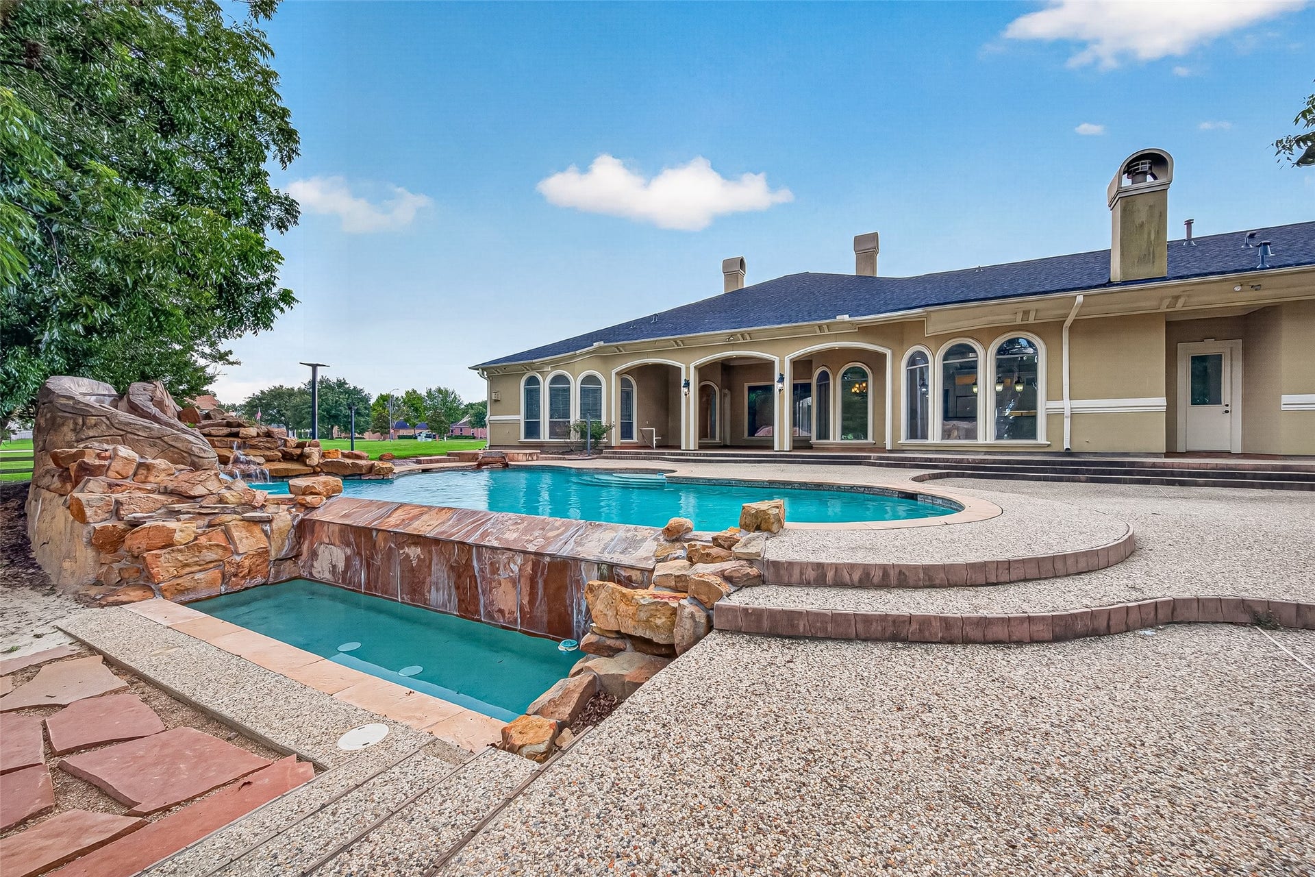 4011 Westerdale Drive, Fulshear, TX 77441 This infinity pool has a waterfall feature that adds to the soothing sounds of nature.