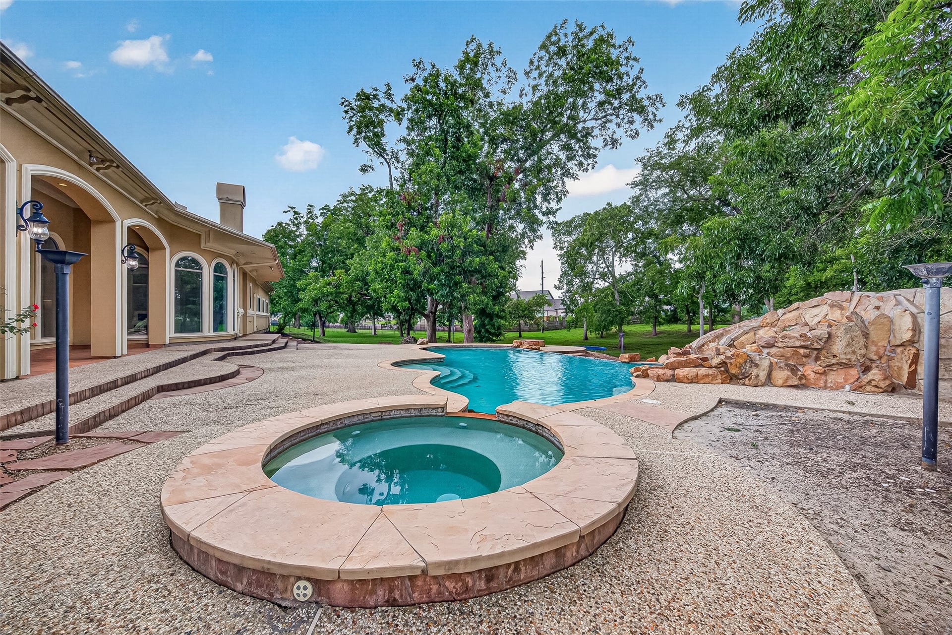4011 Westerdale Drive, Fulshear, TX 77441 The resort style jacuzzi and pool feature a custom masonry natural rock water slide feature.
