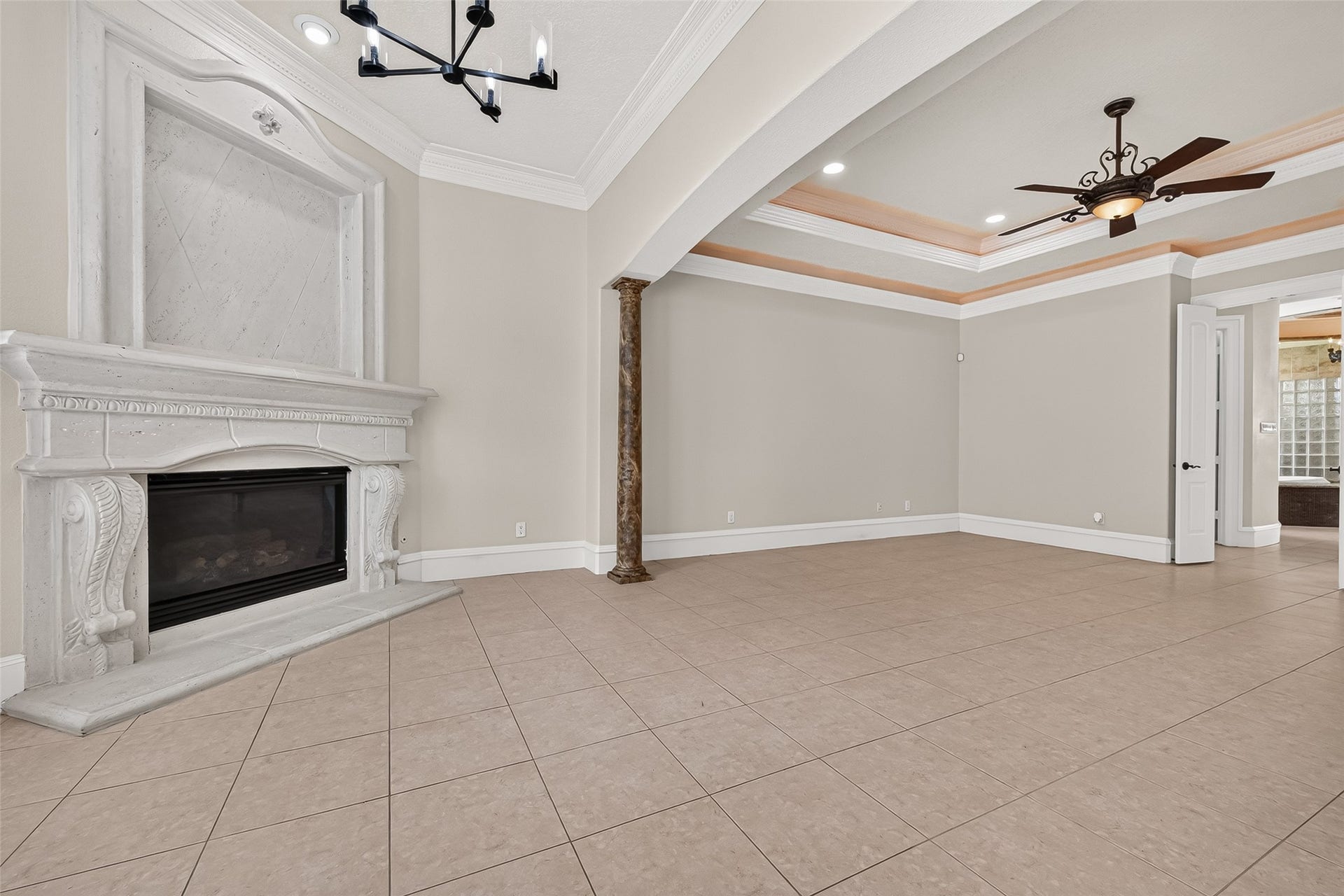 4011 Westerdale Drive, Fulshear, TX 77441 The primary suite's sitting area with a gas fireplace and beautiful arched picture windows that overlook pool and picturesque grounds.