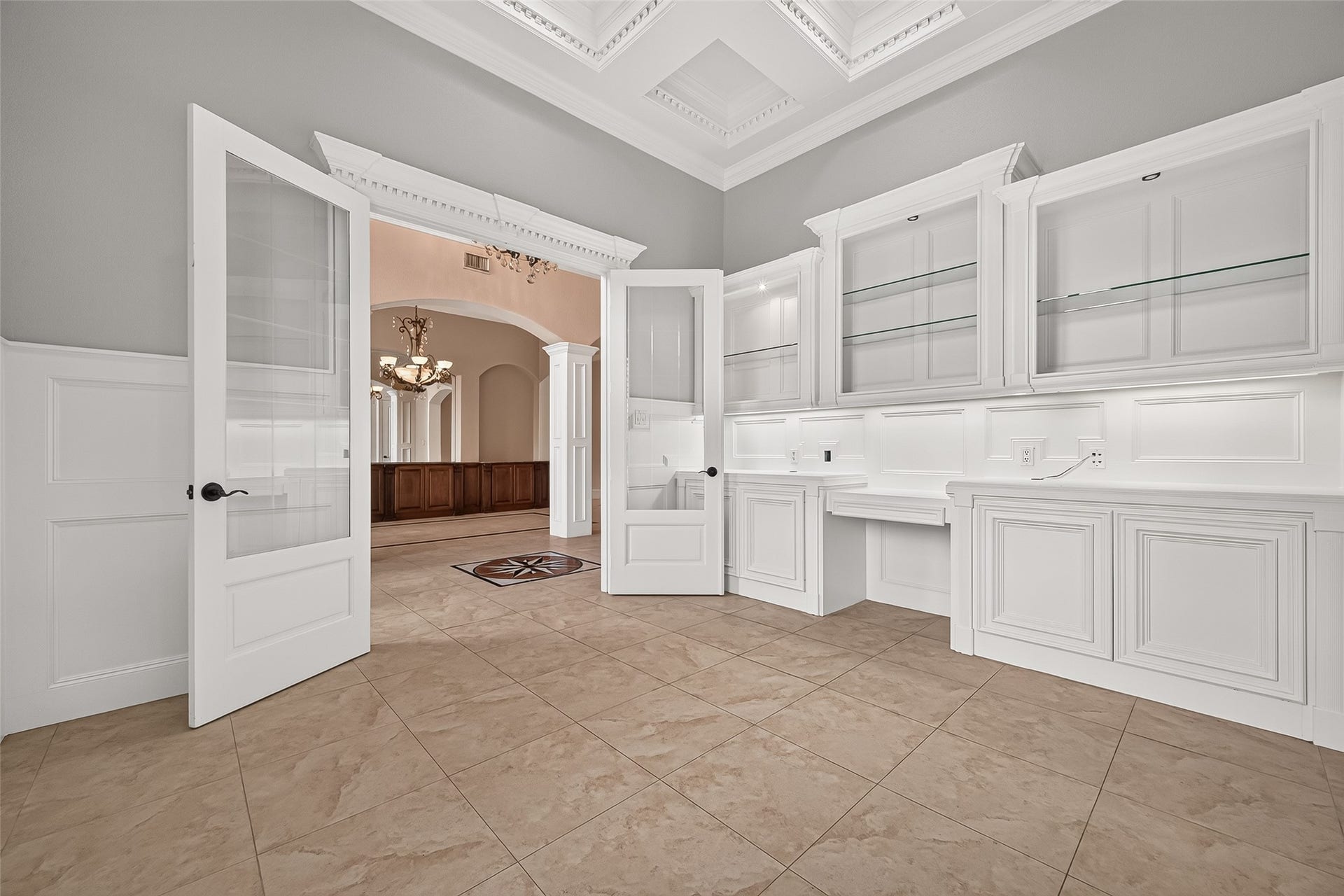 4011 Westerdale Drive, Fulshear, TX 77441 The office is a dramatic space with custom French doors and beveled glass, built in book shelves and cabinets, and crowned with an ornate tray ceiling.