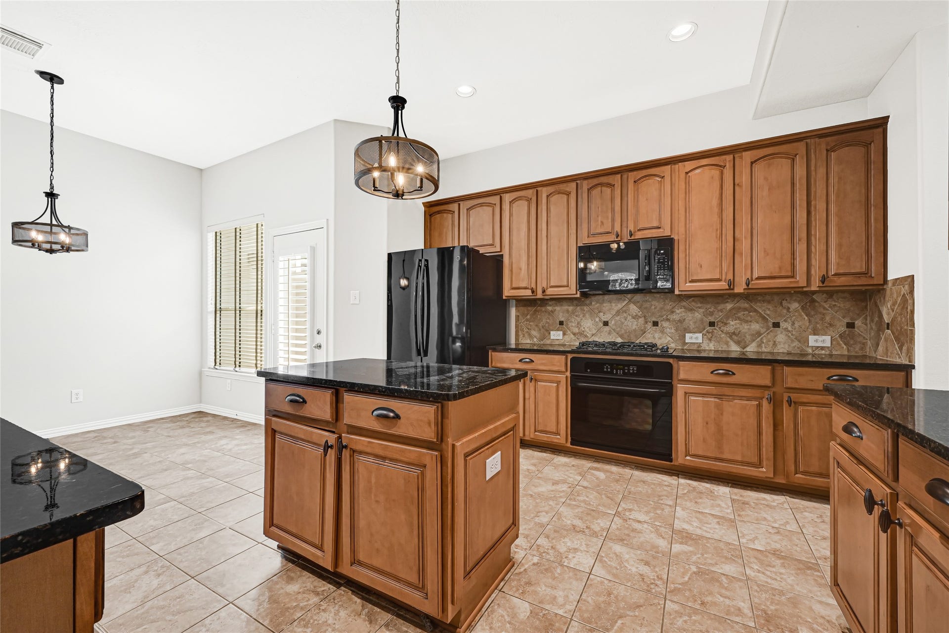 2910 Crescent Oaks Park Lane, Spring, TX 77386 Stunning cabinetry complements the open-concept design, connecting the kitchen to a charming breakfast area.