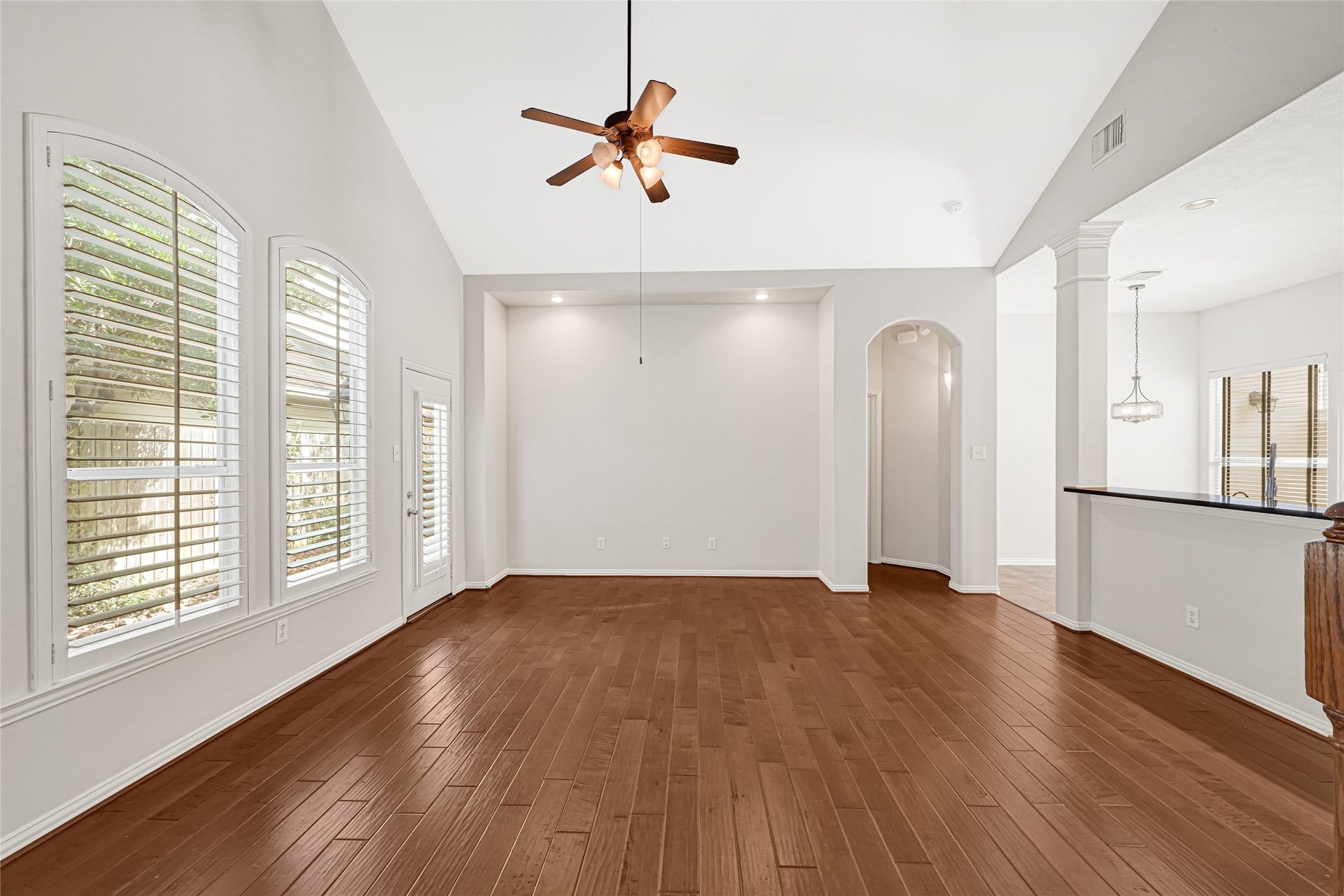 2910 Crescent Oaks Park Lane, Spring, TX 77386 Family room, with plantation shutters and side door leading to the backyard.