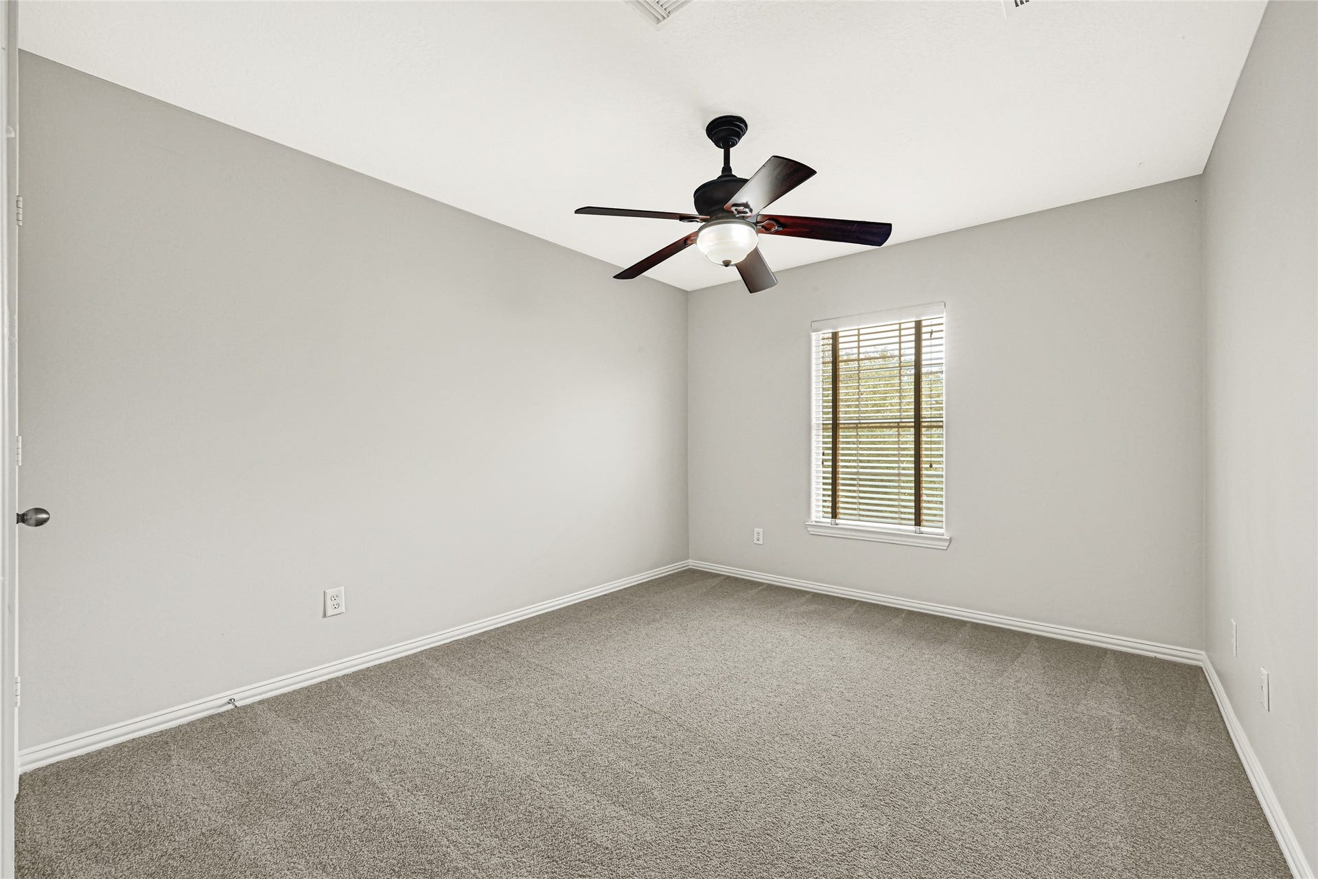 2910 Crescent Oaks Park Lane, Spring, TX 77386 Bedroom 2 features a ceiling fan, fresh paint, and abundant natural light.