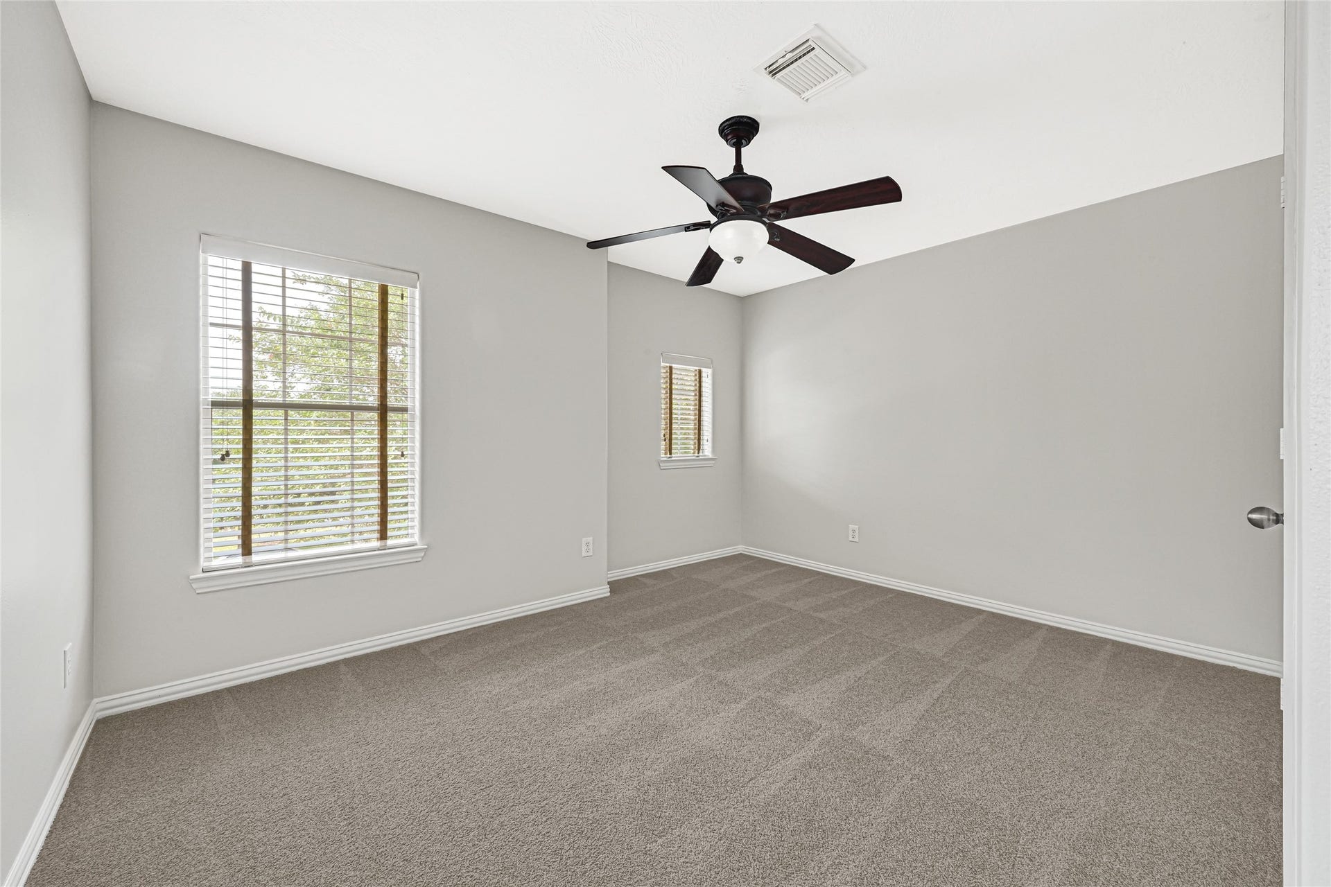2910 Crescent Oaks Park Lane, Spring, TX 77386 Comfortable Bedroom 1 with ceiling fan and beautiful large windows.