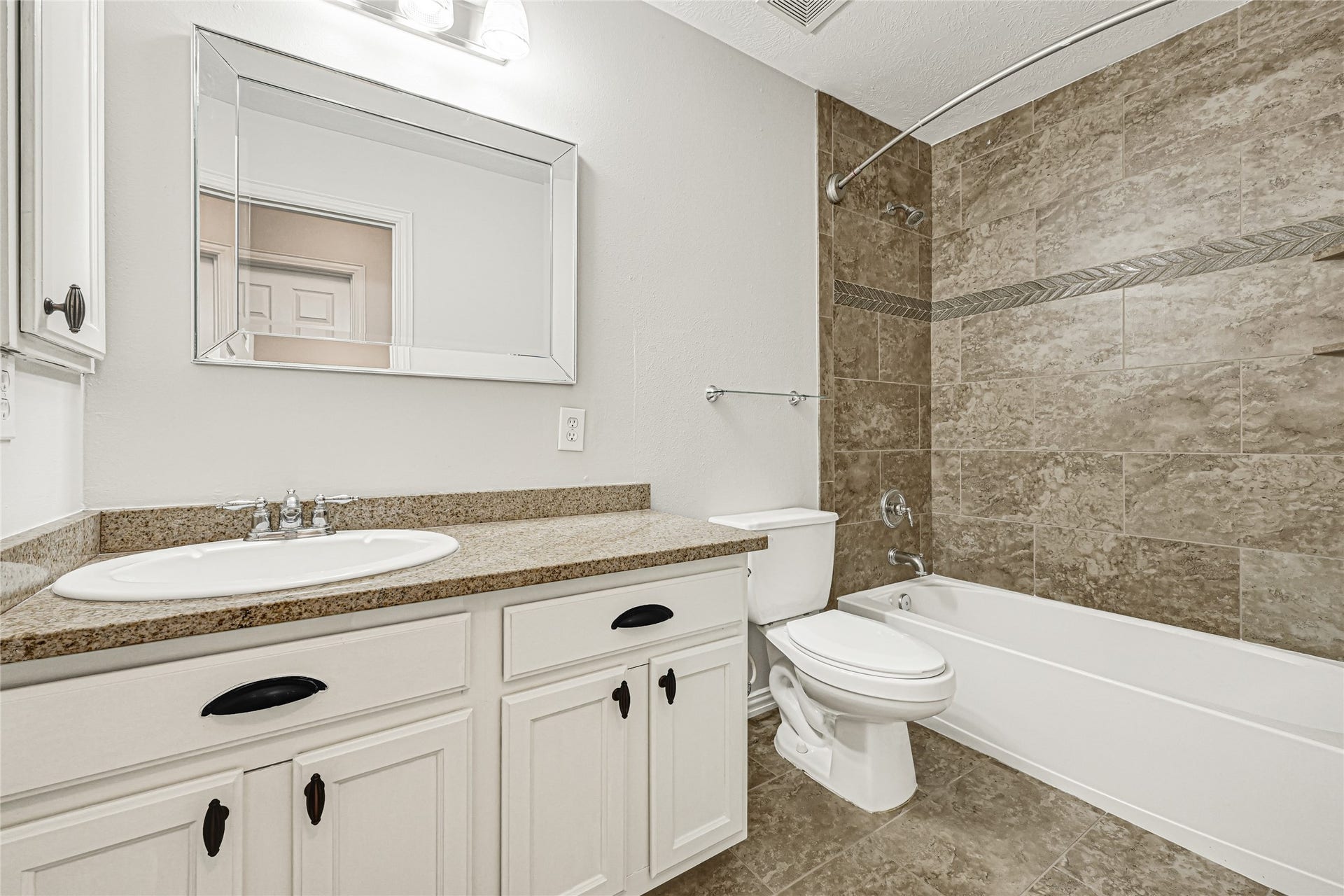 2910 Crescent Oaks Park Lane, Spring, TX 77386 Bathroom features a shower/tub combo with tile extending to the ceiling for a custom finish.