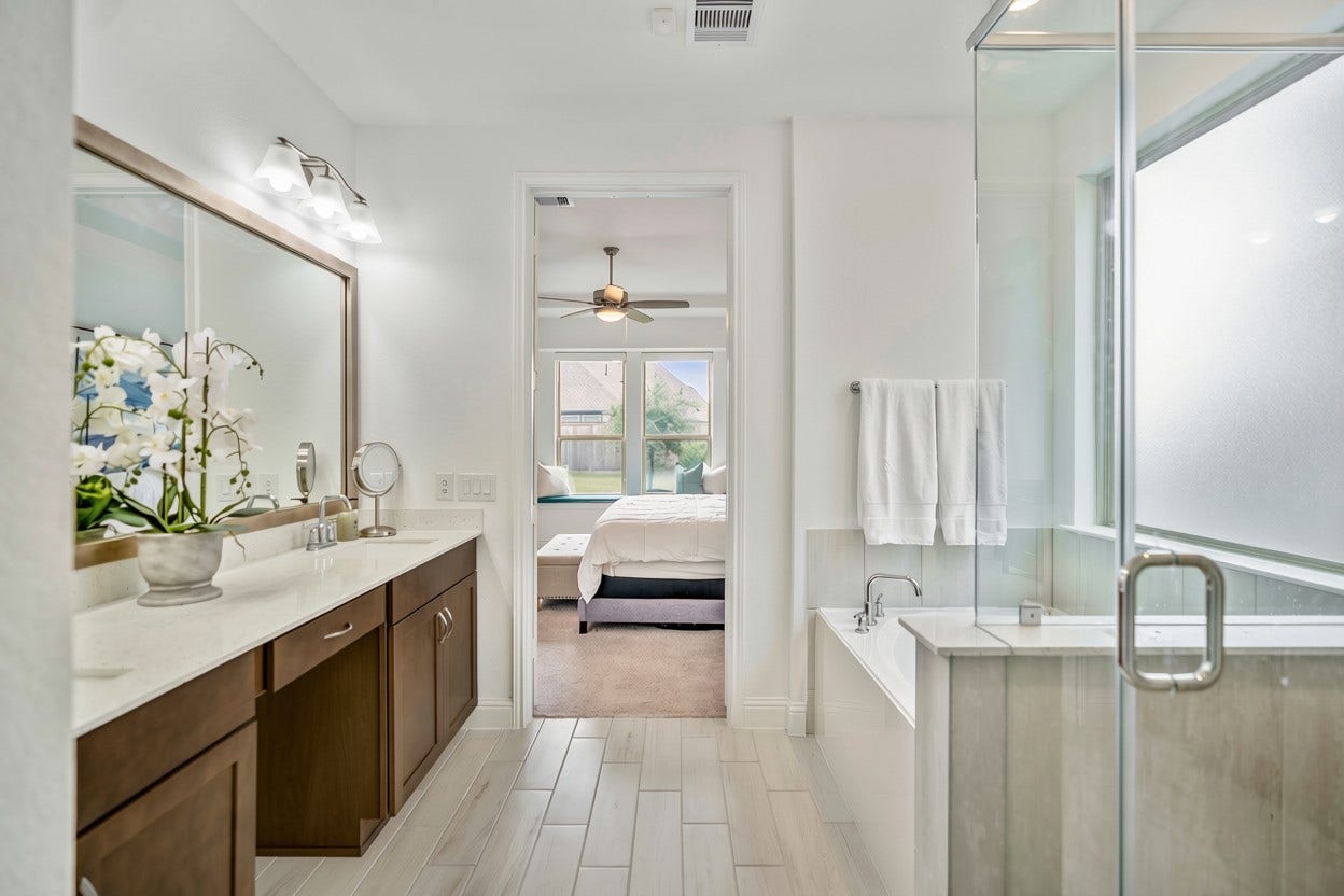 21723 Cordia Trace, Cypress, TX 77433 A separate glass-enclosed shower and soaking tub give you the best of both worlds, with neutral finishes that keep the room bright and easy to personalize.