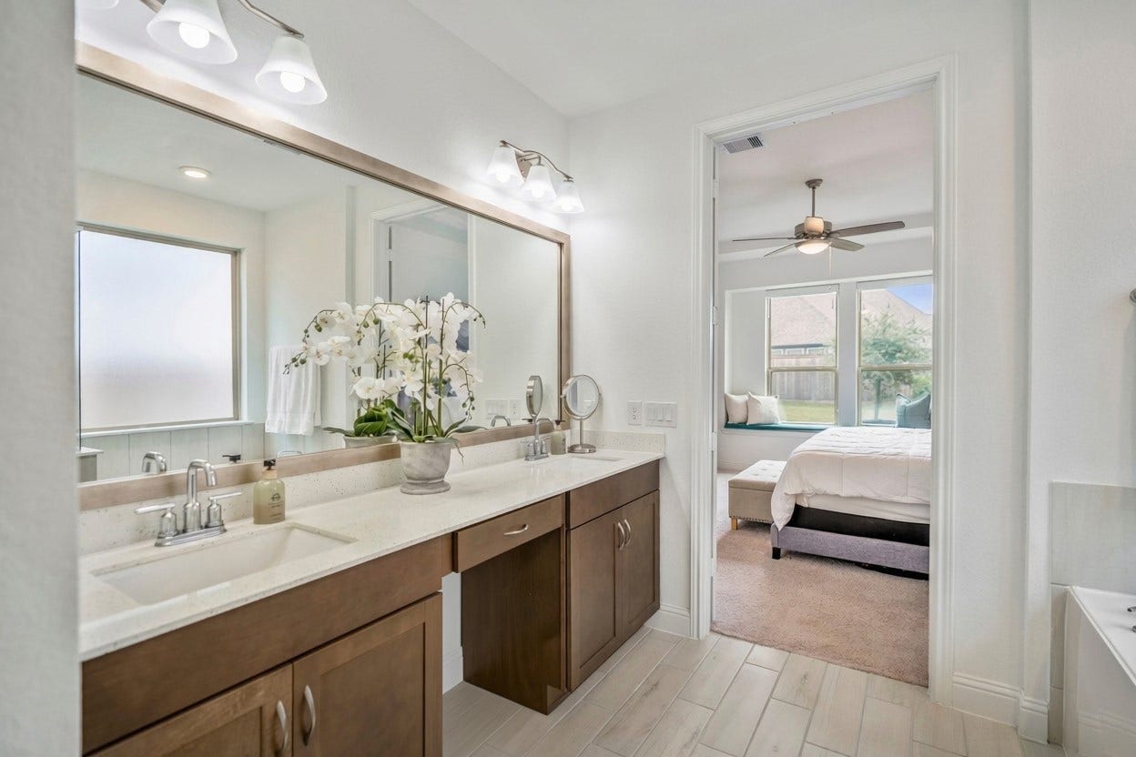 21723 Cordia Trace, Cypress, TX 77433 Another angle shows the generous vanity storage and the separation between the tub and shower, creating a practical layout for busy mornings and slower evenings.