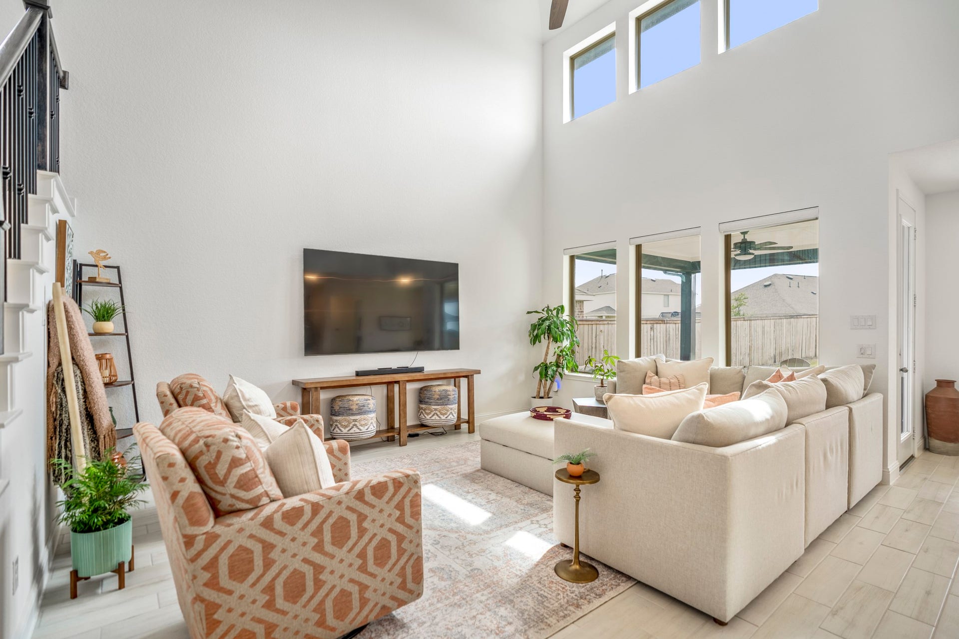 21723 Cordia Trace, Cypress, TX 77433 This wide-angle view captures the main level beautifullythe dramatic ceiling height, natural light and open kitchen all working together to create one large gathering space.