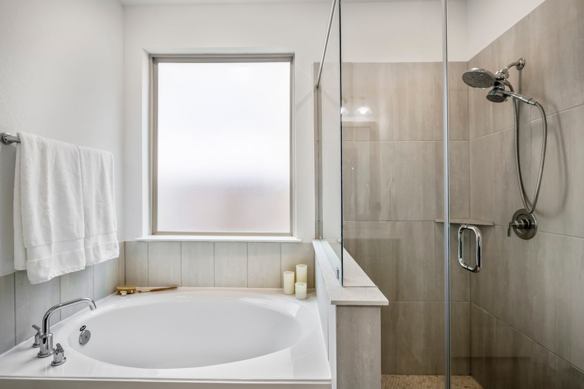 21723 Cordia Trace, Cypress, TX 77433 A closer look at the primary bath highlights the inviting soaking tub, surrounded by neutral finishes and natural light for a calm, relaxing feel.