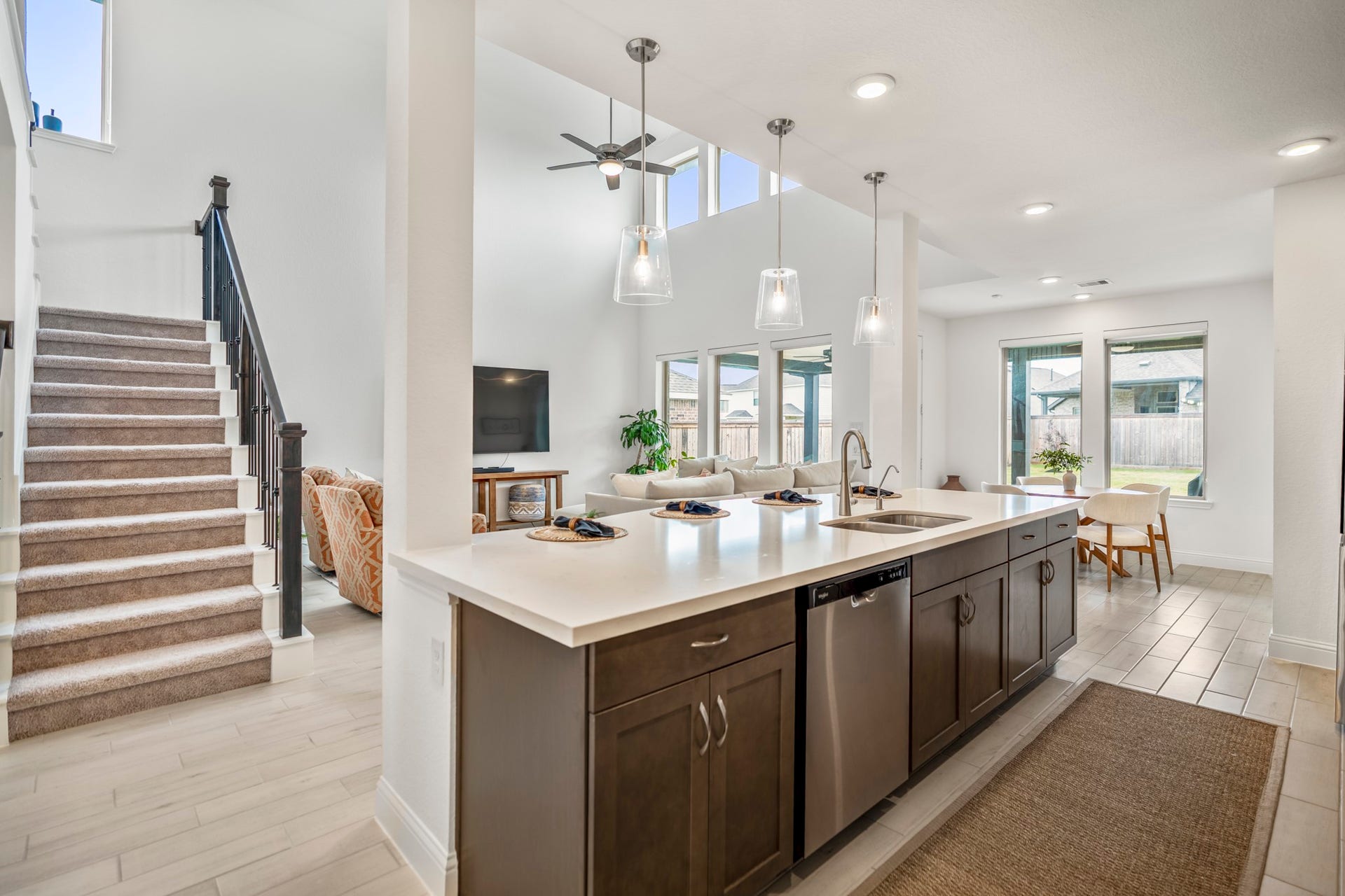 21723 Cordia Trace, Cypress, TX 77433 One of my favorite views because you can finally see how everything connects. The kitchen opens directly toward the dining and two-story family room, making the entire main living area feel connected.