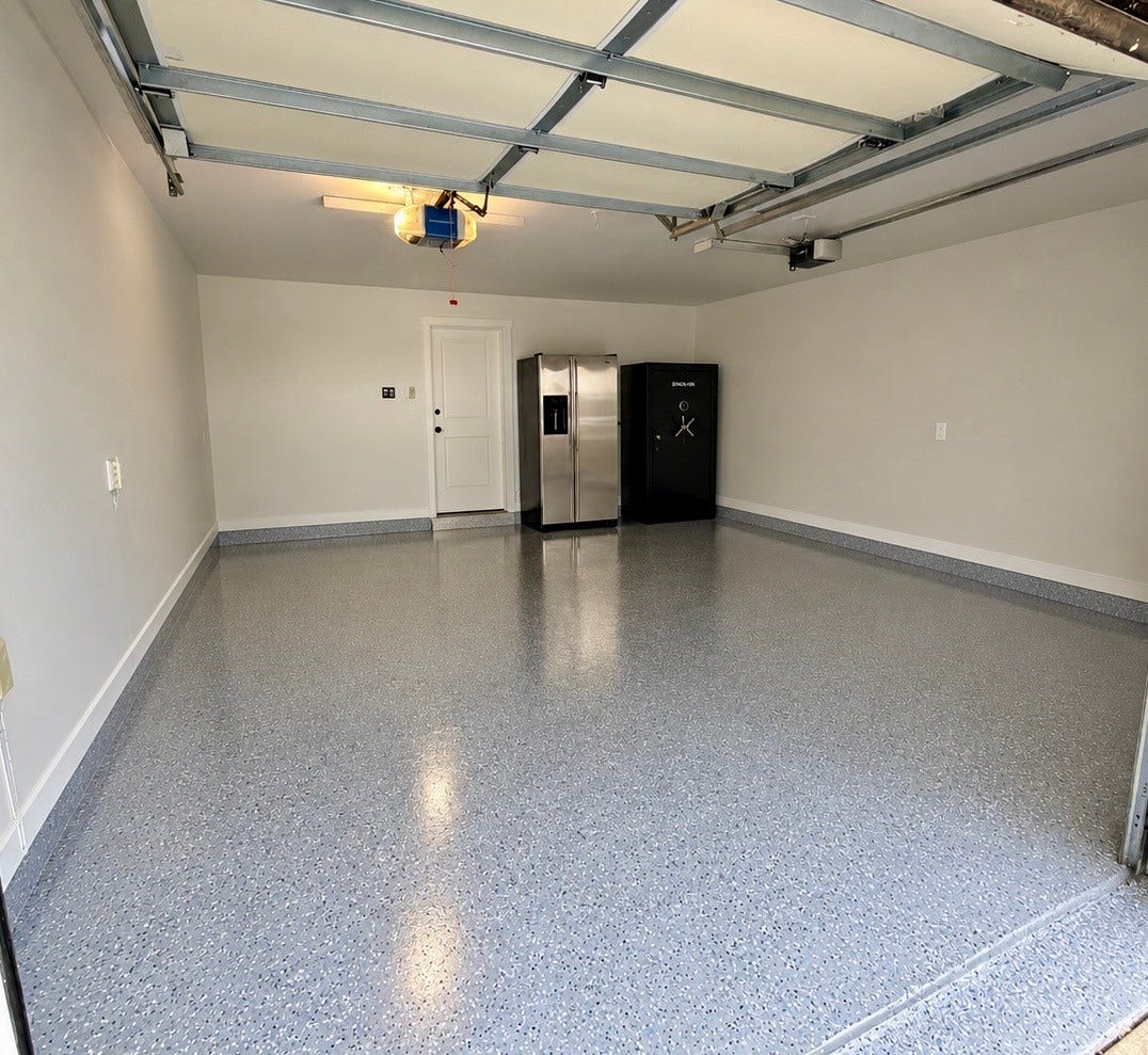 Two car garage with brand new epoxy floor.  Pictured here, refrigerator and safe included!