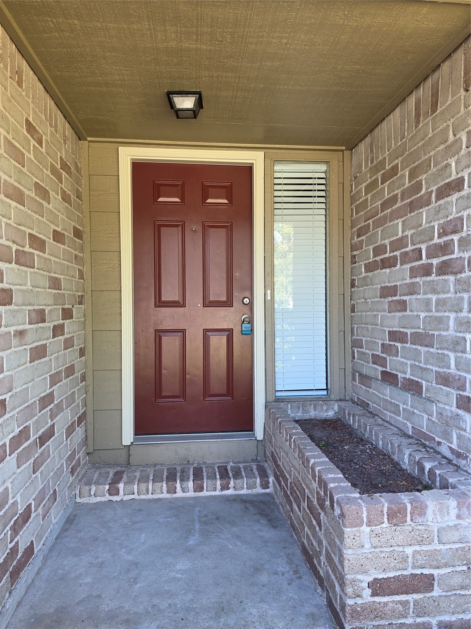 Front porch with cute planting bed.
