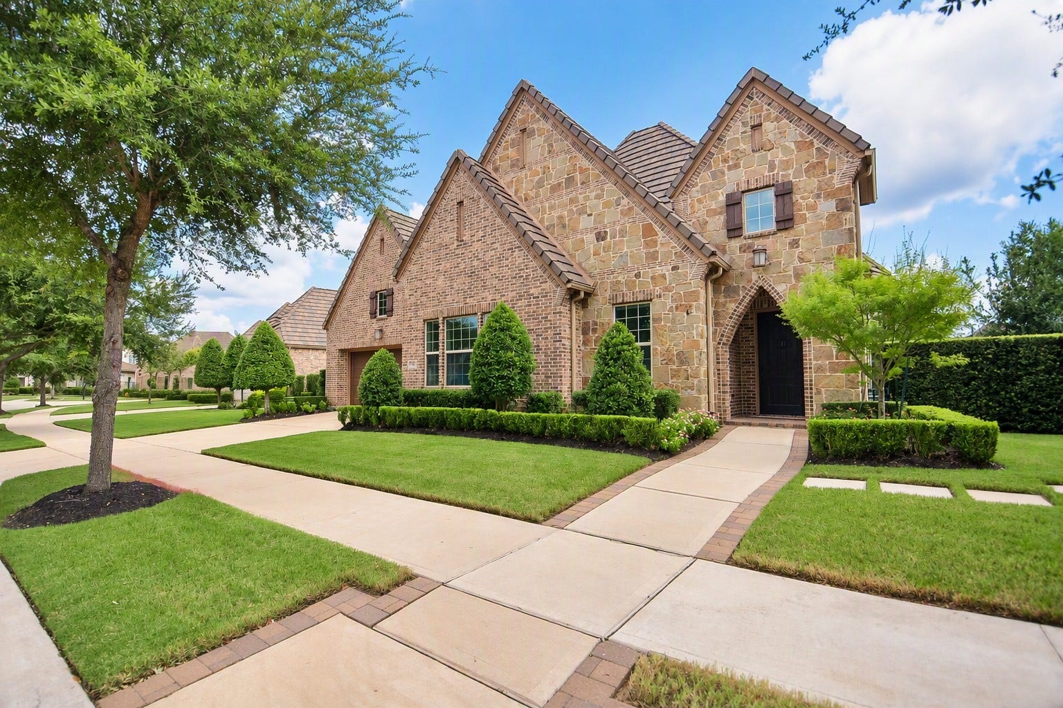 86 Quiet Way Lane, Sugar Land, TX 77498 Impressive brick and stone elevation with manicured landscaping and timeless architectural details