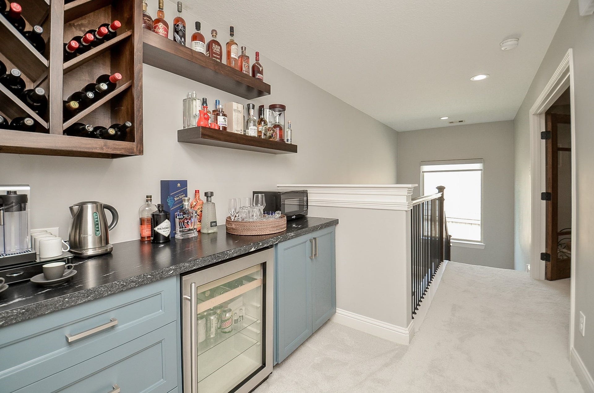 86 Quiet Way Lane, Sugar Land, TX 77498 Custom beverage center with abundant storage, display shelving, and built in beverage refrigerator professionally designed and built by current owners. Double doors open to game room/media room.