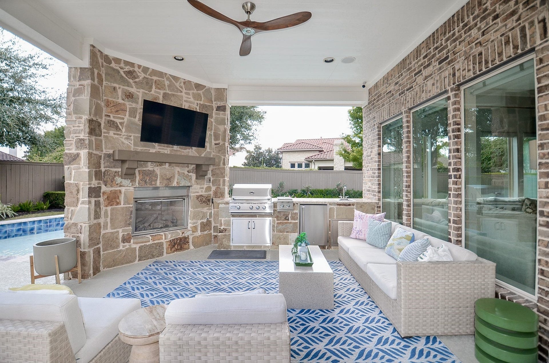 86 Quiet Way Lane, Sugar Land, TX 77498 Covered outdoor living area with stone fireplace and space for year-round enjoyment