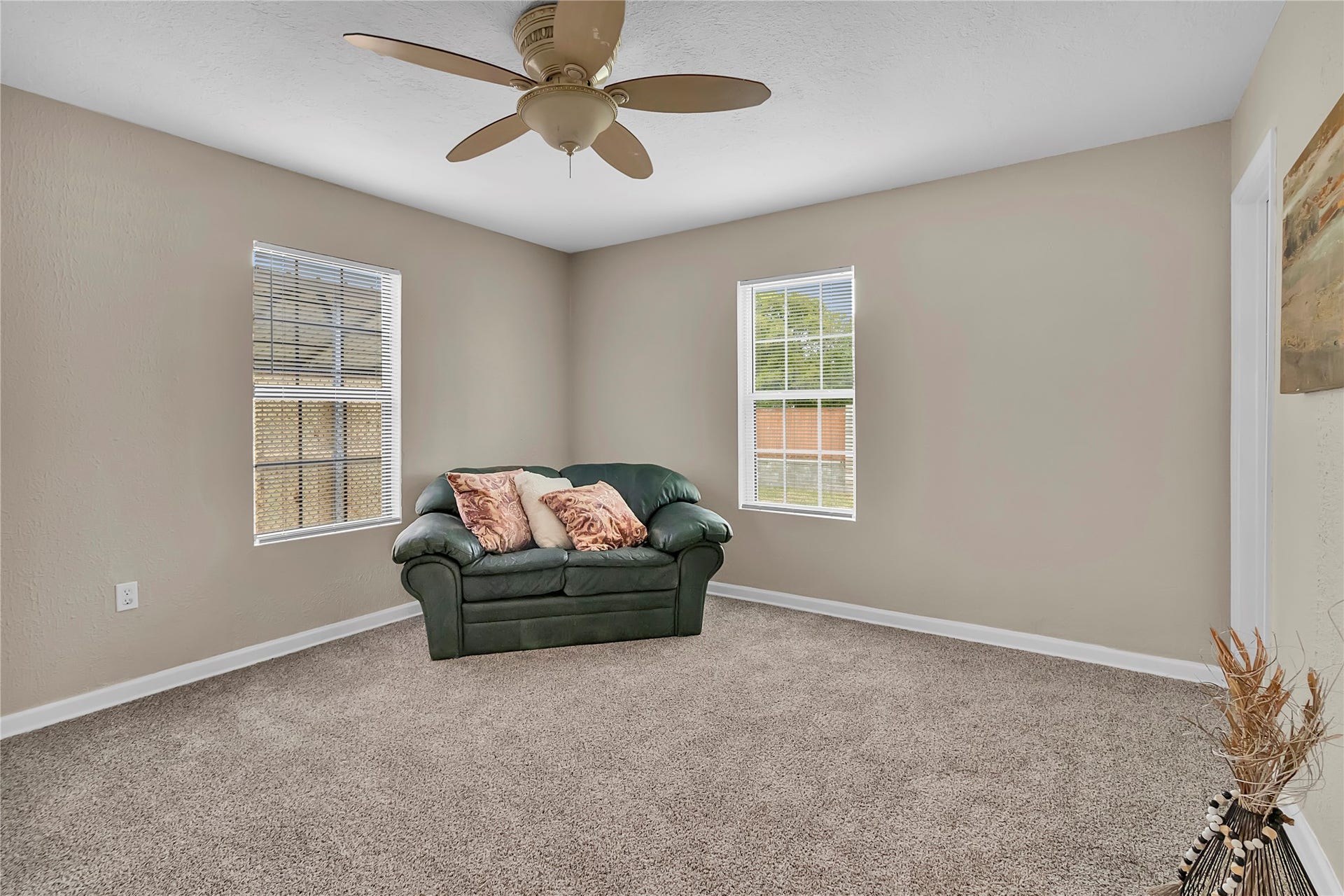 604 19th Avenue N, Texas City, TX 77590 Bright and spacious 4th bedroom with fresh carpet, ceiling fan, and windows overlooking the property.