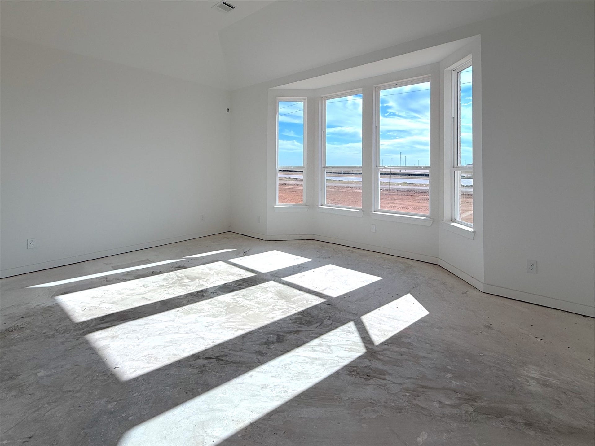 Ample space in the primary bedroom featuring a bay window with lots of natural light.