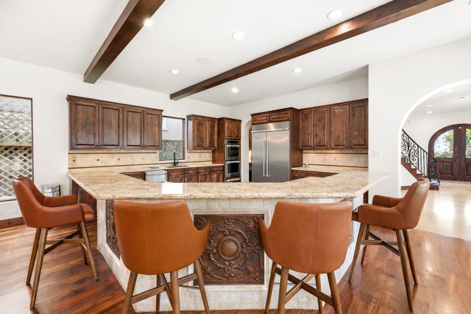 3803 Drake Street, Houston, TX 77005 The kitchen is anchored by a high-end, built-in Kitchen-Aid refrigerator and custom cabinetry, providing ample storage and a refined look for the modern chef.