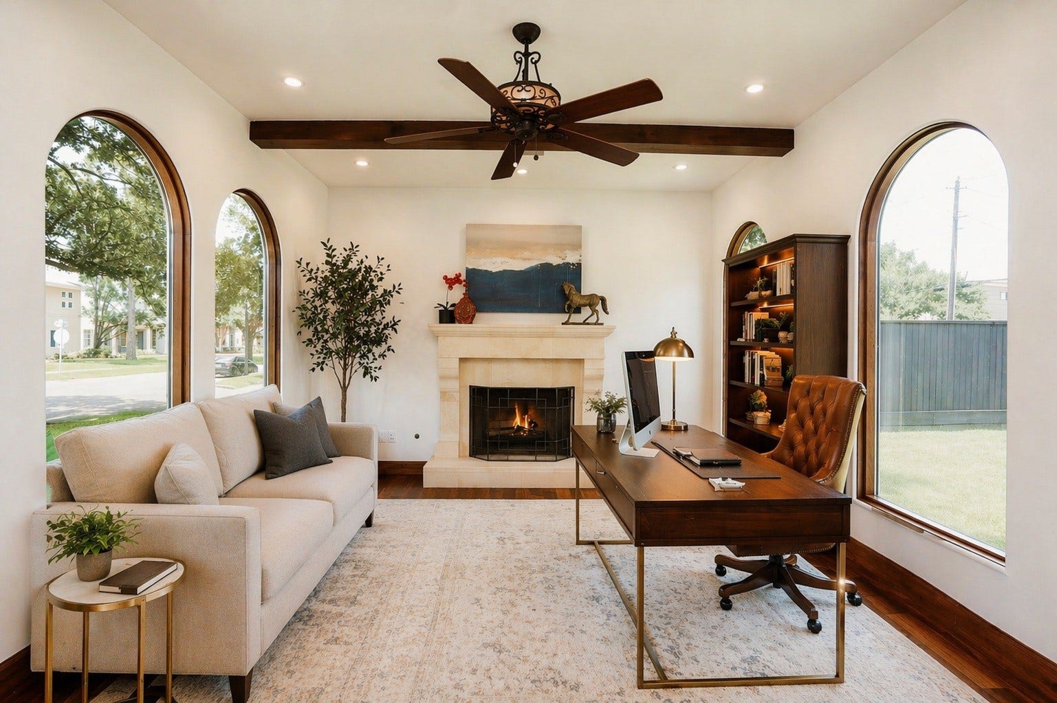 3803 Drake Street, Houston, TX 77005 The dedicated home office features a stately fireplace, rich wood floors, and picturesque arched windows. This space combines architectural elegance with abundant natural light to create a quiet, productive environment. Virtually staged.