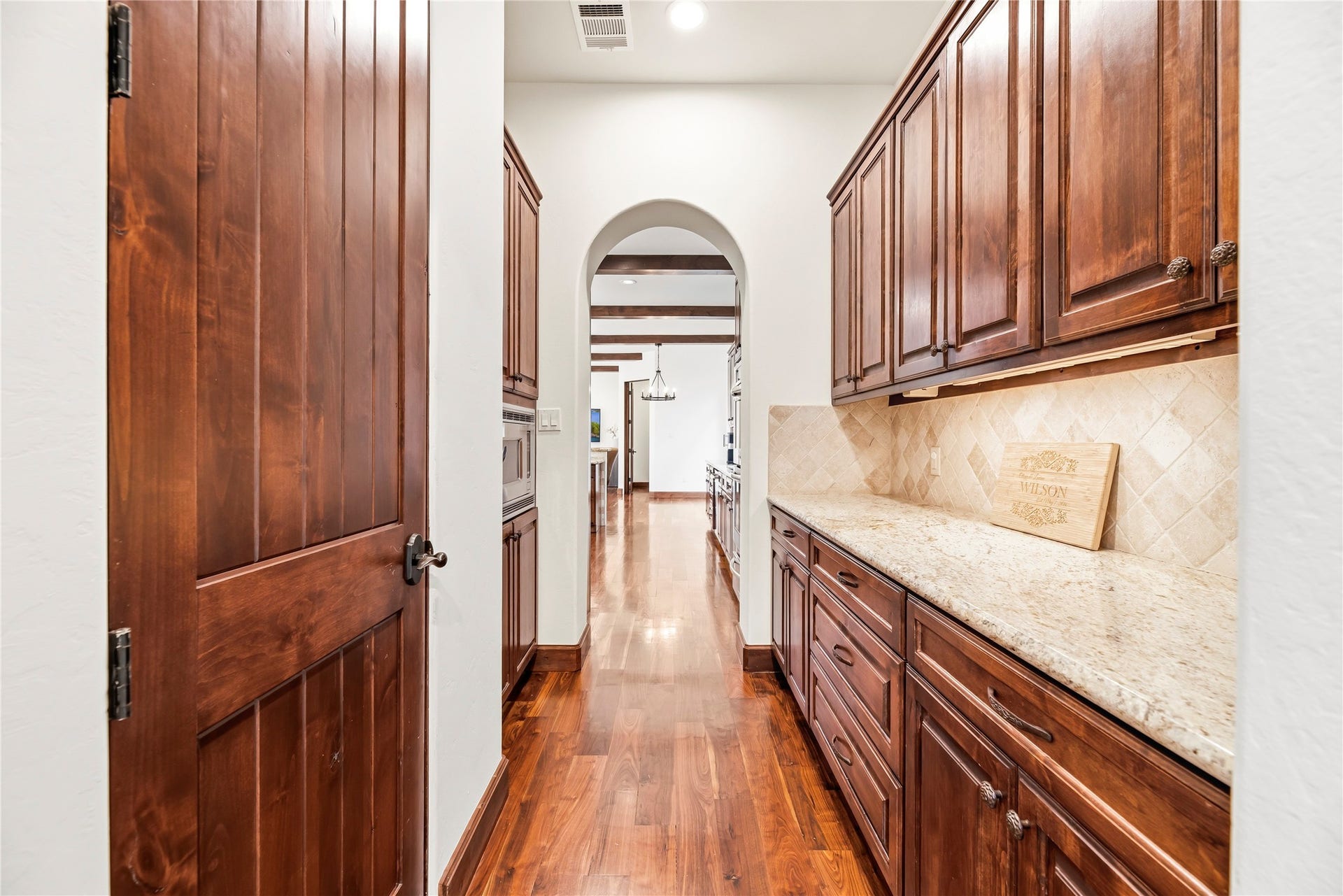 3803 Drake Street, Houston, TX 77005 A refined butler's pantry offers additional granite counter space and storage, providing an elegant transition between the kitchen and formal dining areas.