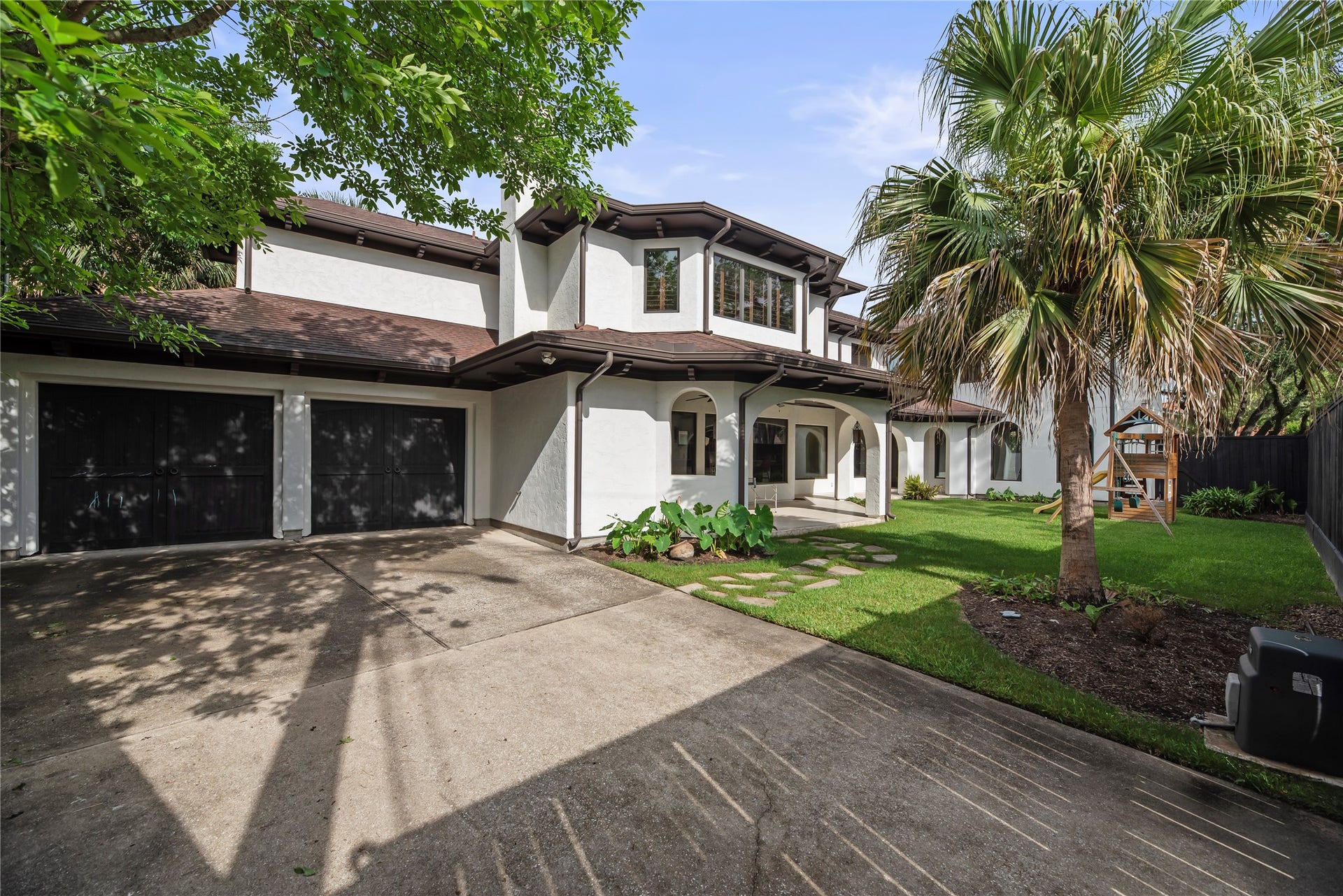 3803 Drake Street, Houston, TX 77005 The oversized two-car garage is complemented by a wide driveway, providing ample space for vehicle storage and guest parking.