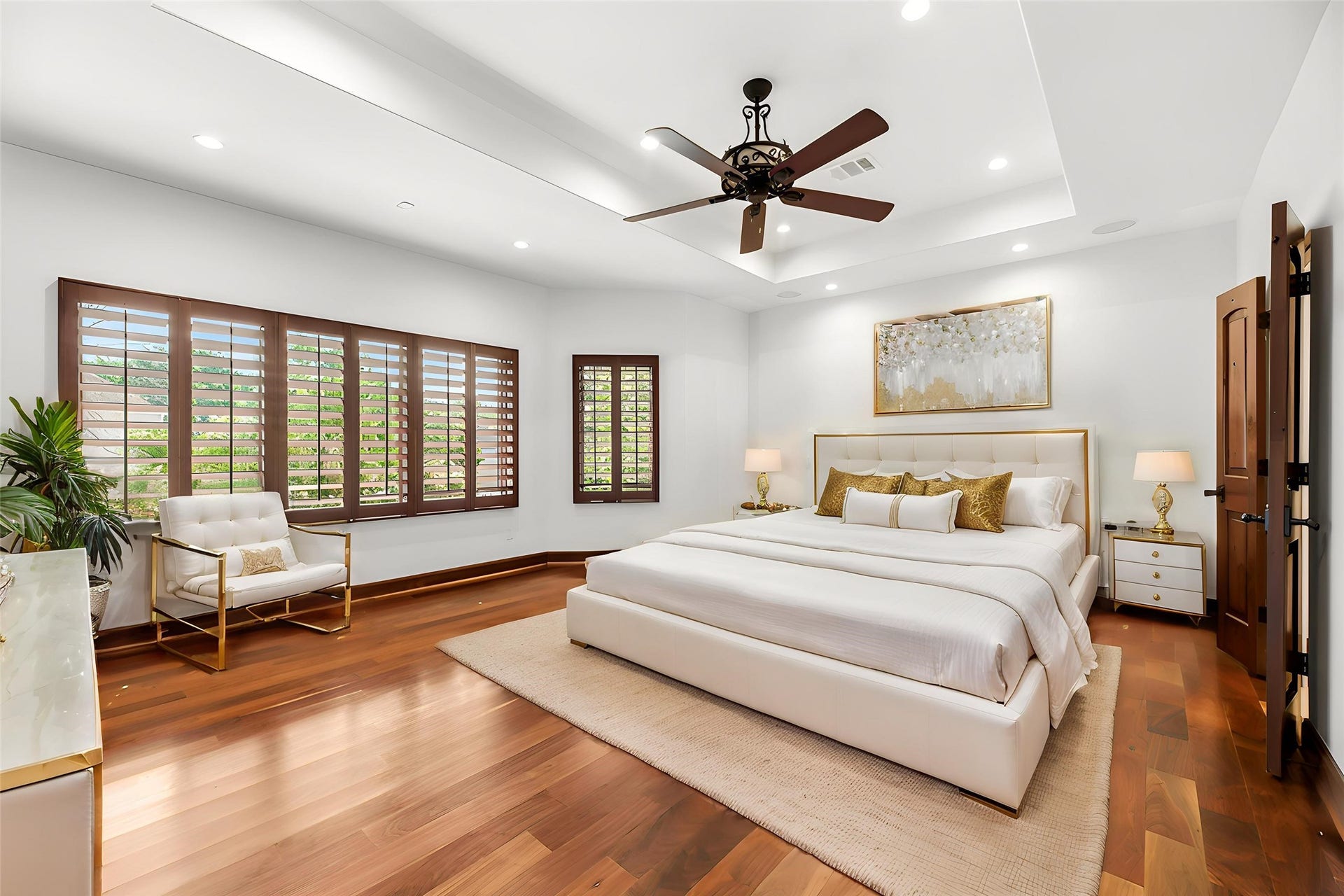 3803 Drake Street, Houston, TX 77005 The expansive Primary Suite features tray ceilings, rich wood floors, and large windows that fill the room with a serene glow for ultimate relaxation. Virtually staged.