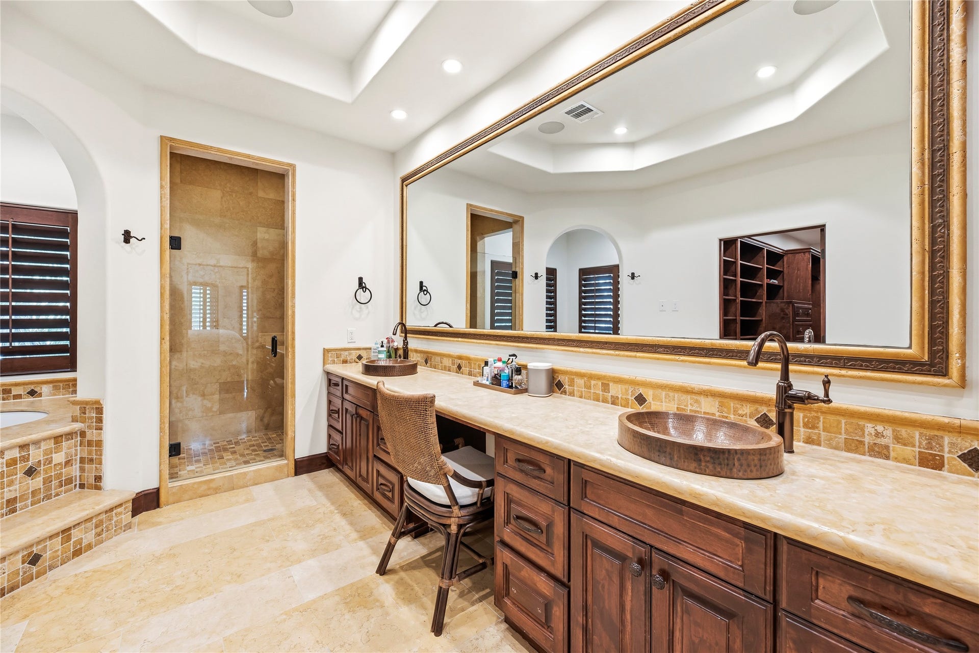 3803 Drake Street, Houston, TX 77005 This sophisticated en-suite sanctuary features custom copper sinks set into expansive granite vanities. Every detail provides a refined atmosphere, offering a spacious and elegant environment for your morning routine.